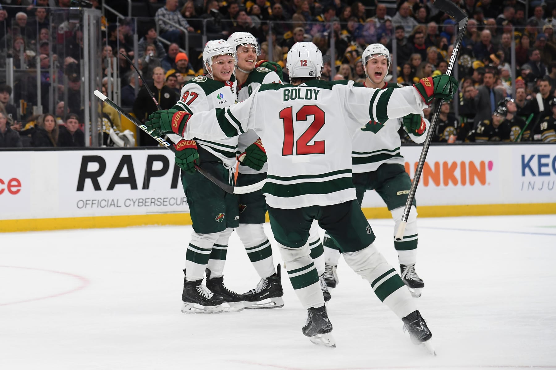 BOSTON, MASSACHUSETTS - DECEMBER 19: Matt Boldy #12, Kirill Kaprizov #97 and Joel Eriksson Ek #14 of the Minnesota Wild celebrate the third-period goal against the Boston Bruins on December 19, 2023 at the TD Garden in Boston, Massachusetts. (Photo by Steve Babineau/NHLI via Getty Images)