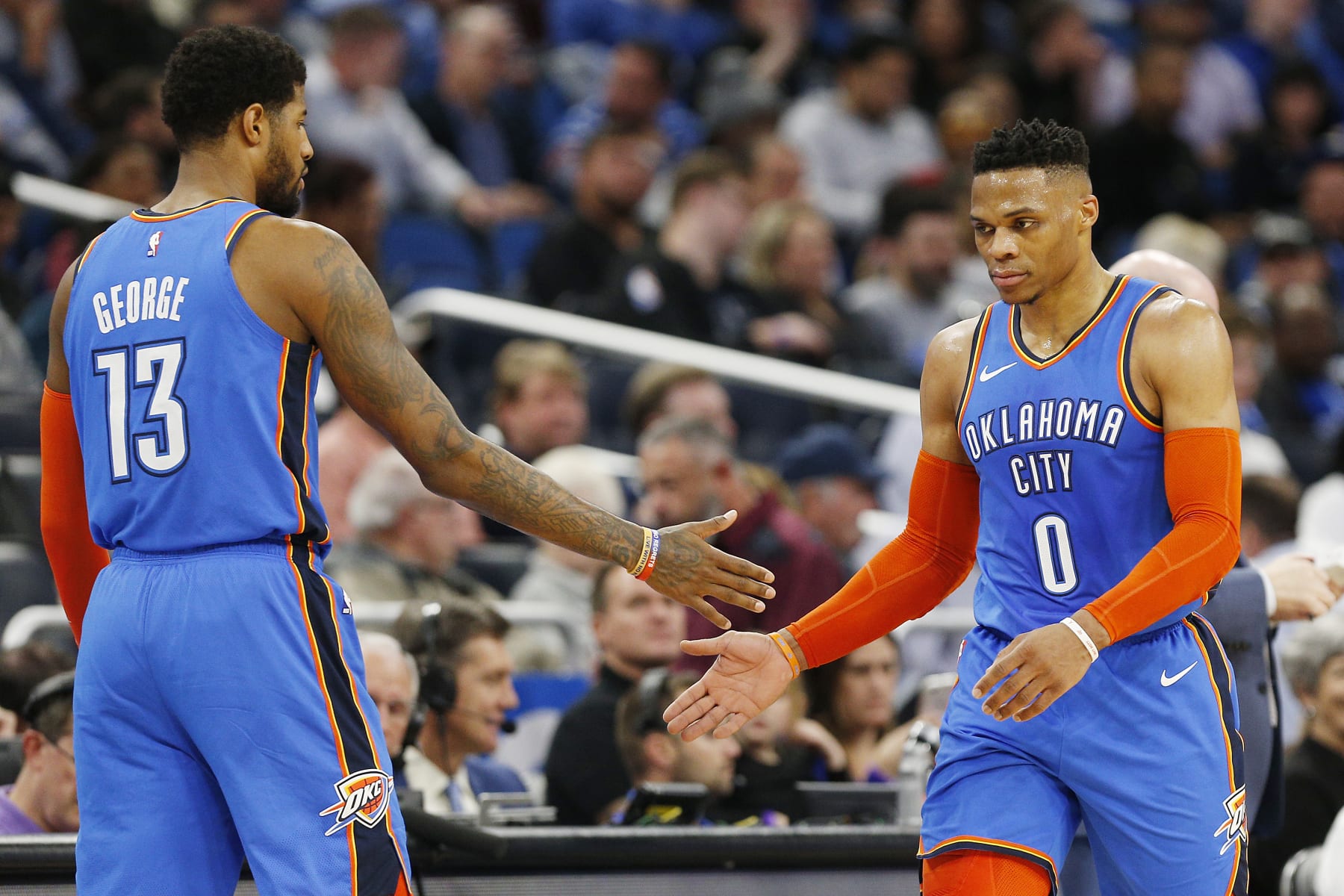 ORLANDO, FLORIDA - JANUARY 29:  Paul George #13 of the Oklahoma City Thunder (L) celebrates with Russell Westbrook #0 against the Orlando Magic during the first half at Amway Center on January 29, 2019 in Orlando, Florida. NOTE TO USER: User expressly acknowledges and agrees that, by downloading and or using this photograph, User is consenting to the terms and conditions of the Getty Images License Agreement. (Photo by Michael Reaves/Getty Images)