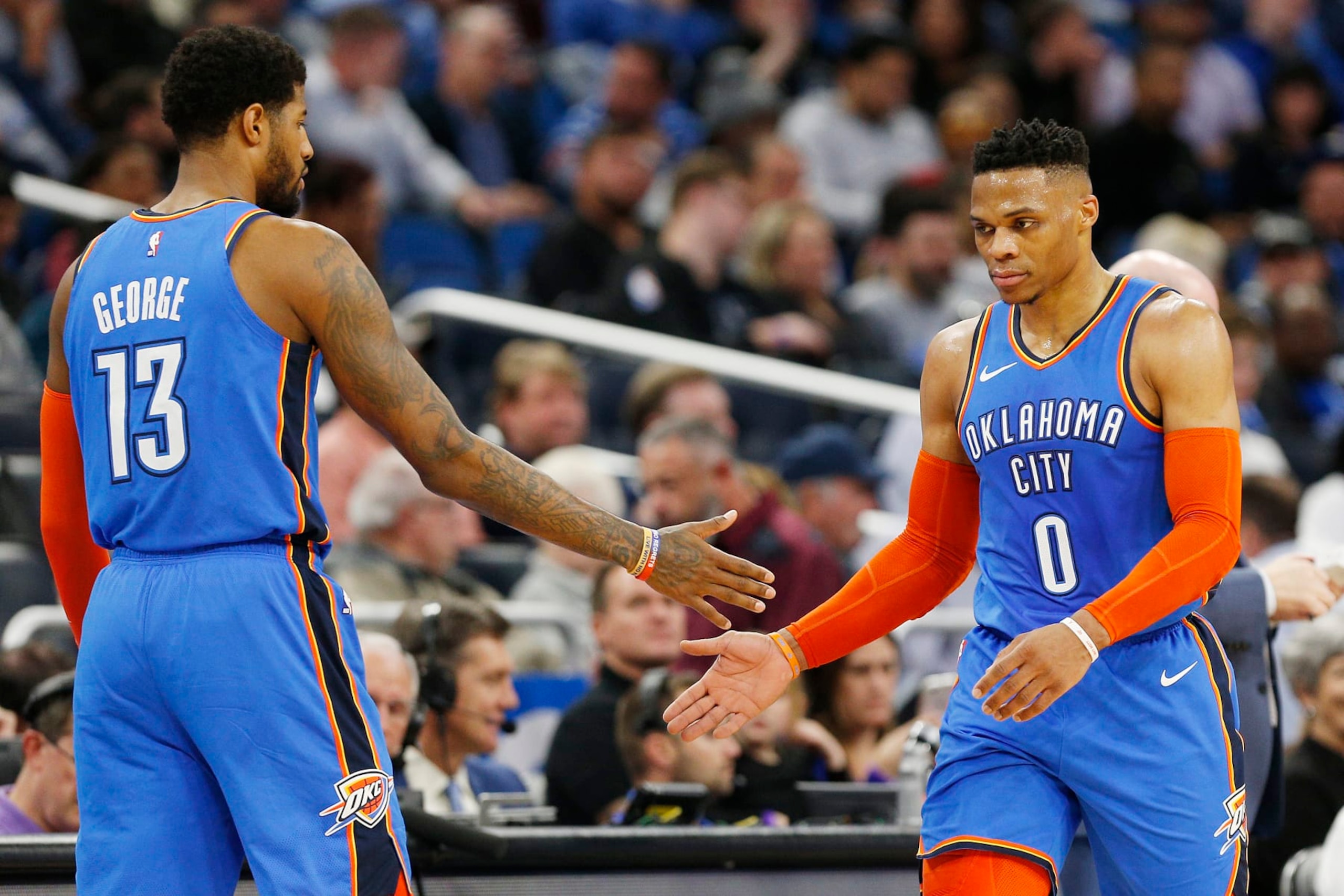 ORLANDO, FLORIDA - JANUARY 29:  Paul George #13 of the Oklahoma City Thunder (L) celebrates with Russell Westbrook #0 against the Orlando Magic during the first half at Amway Center on January 29, 2019 in Orlando, Florida. NOTE TO USER: User expressly acknowledges and agrees that, by downloading and or using this photograph, User is consenting to the terms and conditions of the Getty Images License Agreement. (Photo by Michael Reaves/Getty Images)