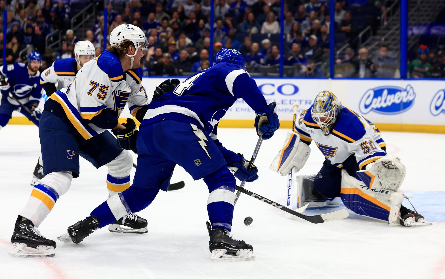 TAMPA, FLORIDA - DECEMBER 19: Jordan Binnington #50 of the St. Louis Blues stops a shot from Tanner Jeannot #84 of the Tampa Bay Lightning in the second period during a game  at Amalie Arena on December 19, 2023 in Tampa, Florida. (Photo by Mike Ehrmann/Getty Images)