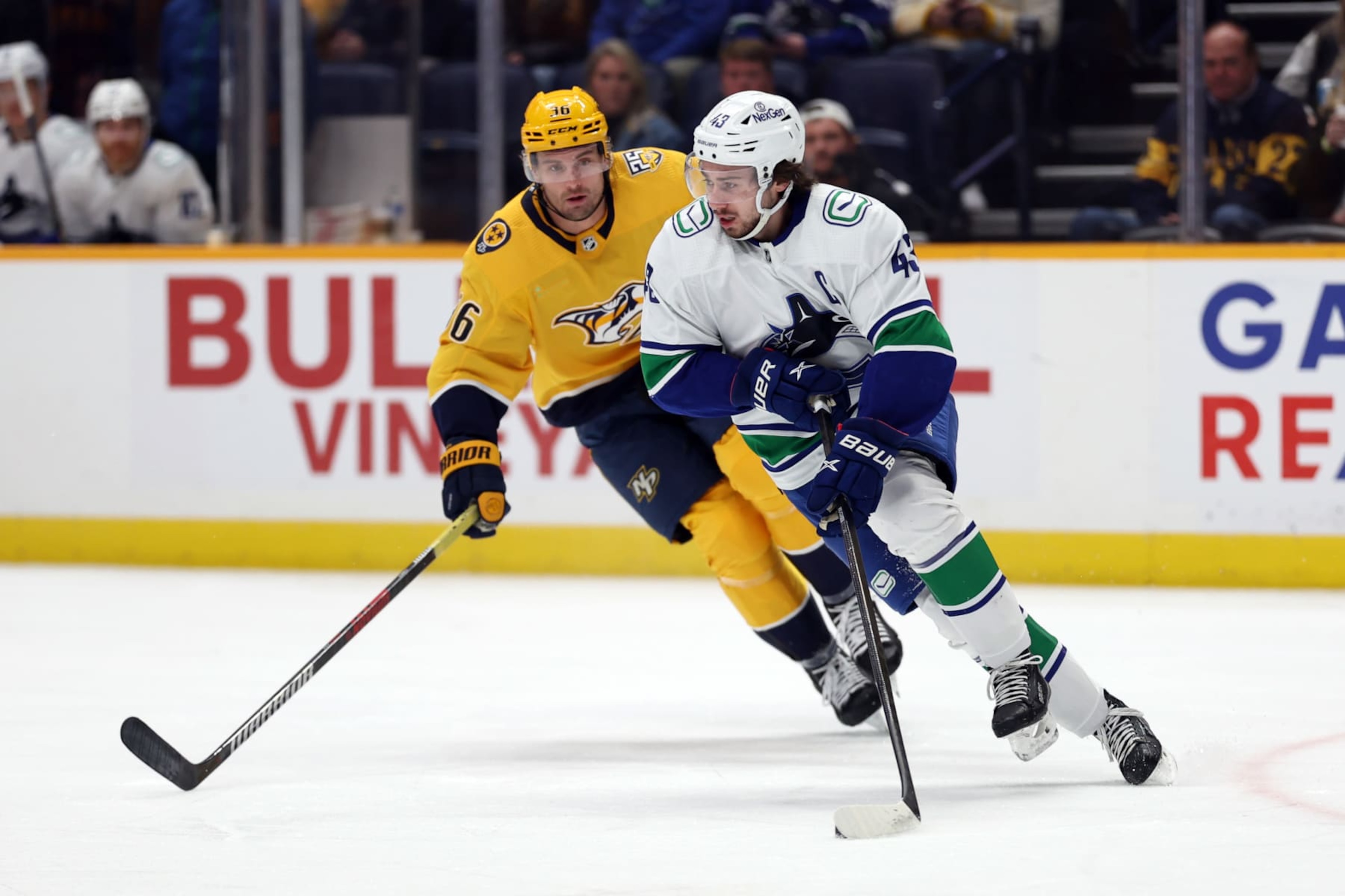 NASHVILLE, TENNESSEE - DECEMBER 19: Quinn Hughes #43 of the Vancouver Canucks skates with Cole Smith #36 of the Nashville Predators defending at Bridgestone Arena on December 19, 2023 in Nashville, Tennessee. The Vancouver Canucks won the game 5-2. (Photo by Donald Page/Getty Images) NASHVILLE, TENNESSEE - DECEMBER 19: Quinn Hughes #43 of the Vancouver Canucks skates with Cole Smith #36 of the Nashville Predators defending at Bridgestone Arena on December 19, 2023 in Nashville, Tennessee. The Vancouver Canucks won the game 5-2. (Photo by Donald Page/Getty Images)
