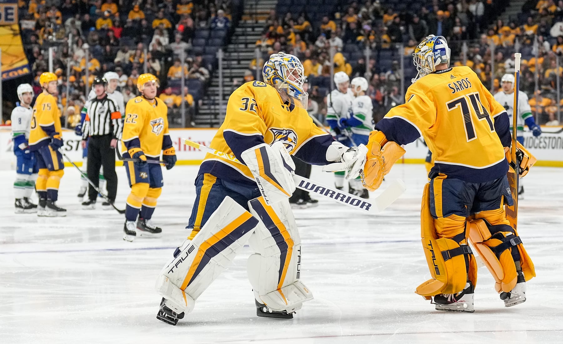 NASHVILLE, TENNESSEE - DECEMBER 19: Kevin Lankinen #32 replaces Juuse Saros #74 of the Nashville Predators in goal against the Vancouver Canucks during an NHL game at Bridgestone Arena on December 19, 2023 in Nashville, Tennessee. (Photo by John Russell/NHLI via Getty Images)