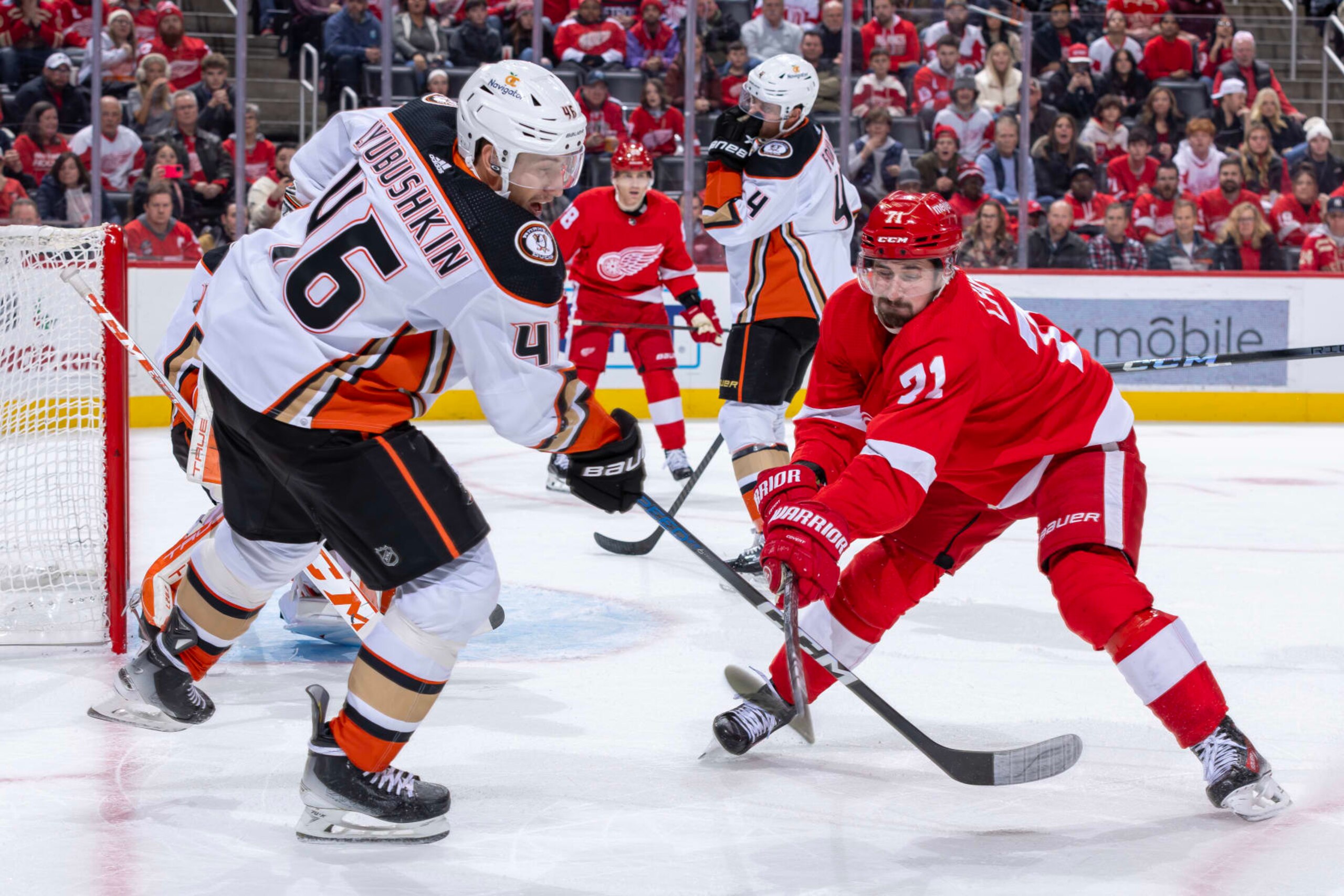 DETROIT, MI - DECEMBER 18: Dylan Larkin #71 of the Detroit Red Wings chops the stick of Ilya Lyubushkin #46 of the Anaheim Ducks during the third period at Little Caesars Arena on December 18, 2023 in Detroit, Michigan. Anaheim defeated Anaheim 4-3. (Photo by Dave Reginek/NHLI via Getty Images)