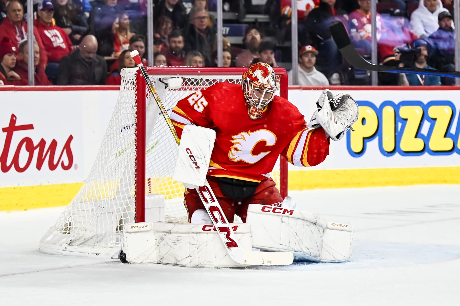 CALGARY, AB - DECEMBER 18: Calgary Flames Goalie Jacob Markstrom (25) makes a glove save during the first period of an NHL game between the Calgary Flames and the Florida Panthers on December 18, 2023, at the Scotiabank Saddledome in Calgary, AB. (Photo by Brett Holmes/Icon Sportswire via Getty Images)