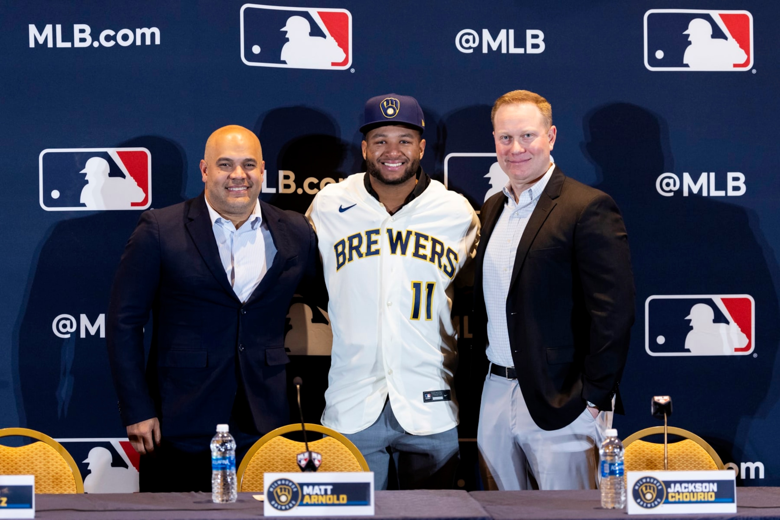 NASHVILE, TN - DECEMBER 04:  Jackson Churio #11 of the Milwaukee Brewers poses for a photo with General Manager Matt Arnold and Cesar Suarez  during the Jackson Chourio Press Conference at the Gaylord Opryland Resort & Convention Center on Monday, December 4, 2023 in Nashvile, Tennessee. (Photo by Casey Gower/MLB Photos via Getty Images)