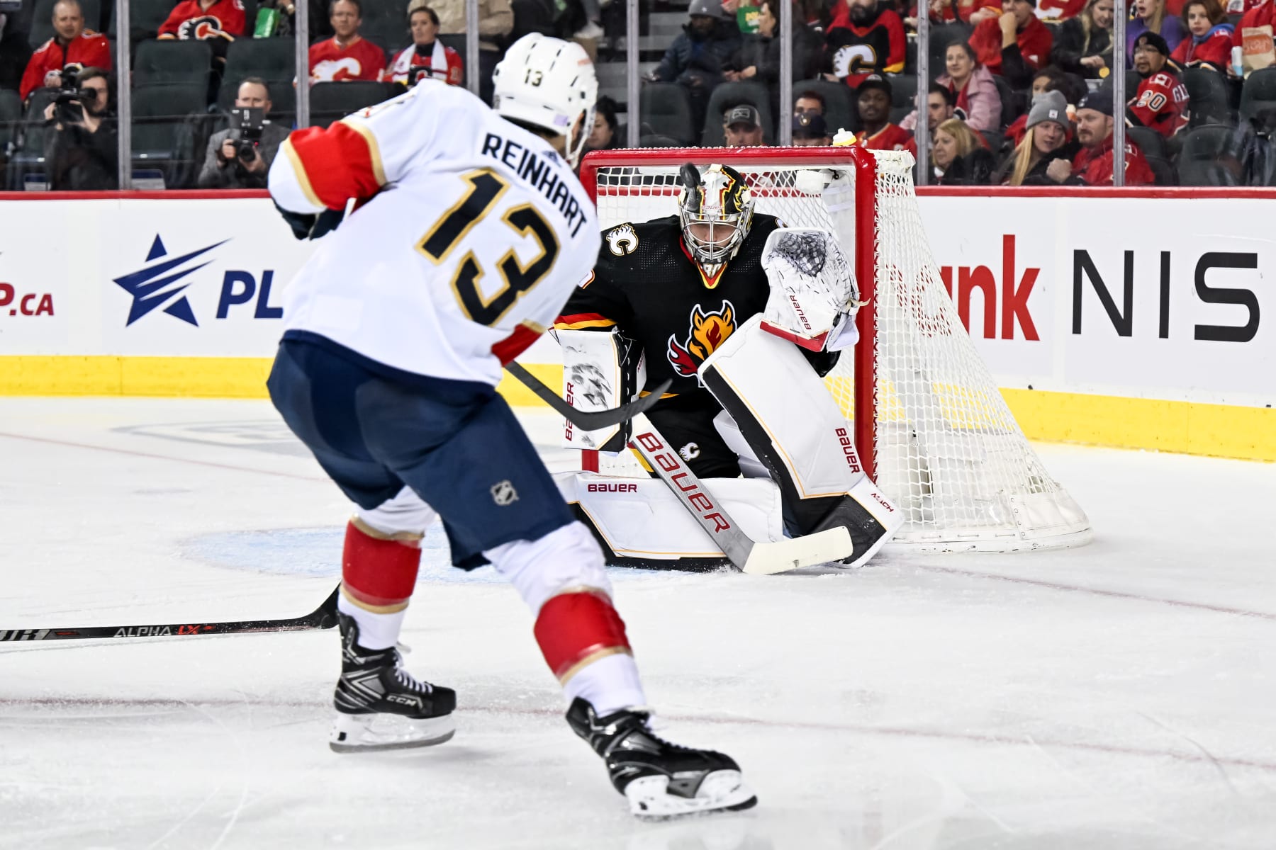 CALGARY, AB - NOVEMBER 29: Calgary Flames Goalie Dan Vladar (80) covers the net as Florida Panthers Right Wing Sam Reinhart (13) takes a shot during the second period of an NHL game between the Calgary Flames and the Florida Panthers on November 29, 2022, at the Scotiabank Saddledome in Calgary, AB. (Photo by Brett Holmes/Icon Sportswire via Getty Images)