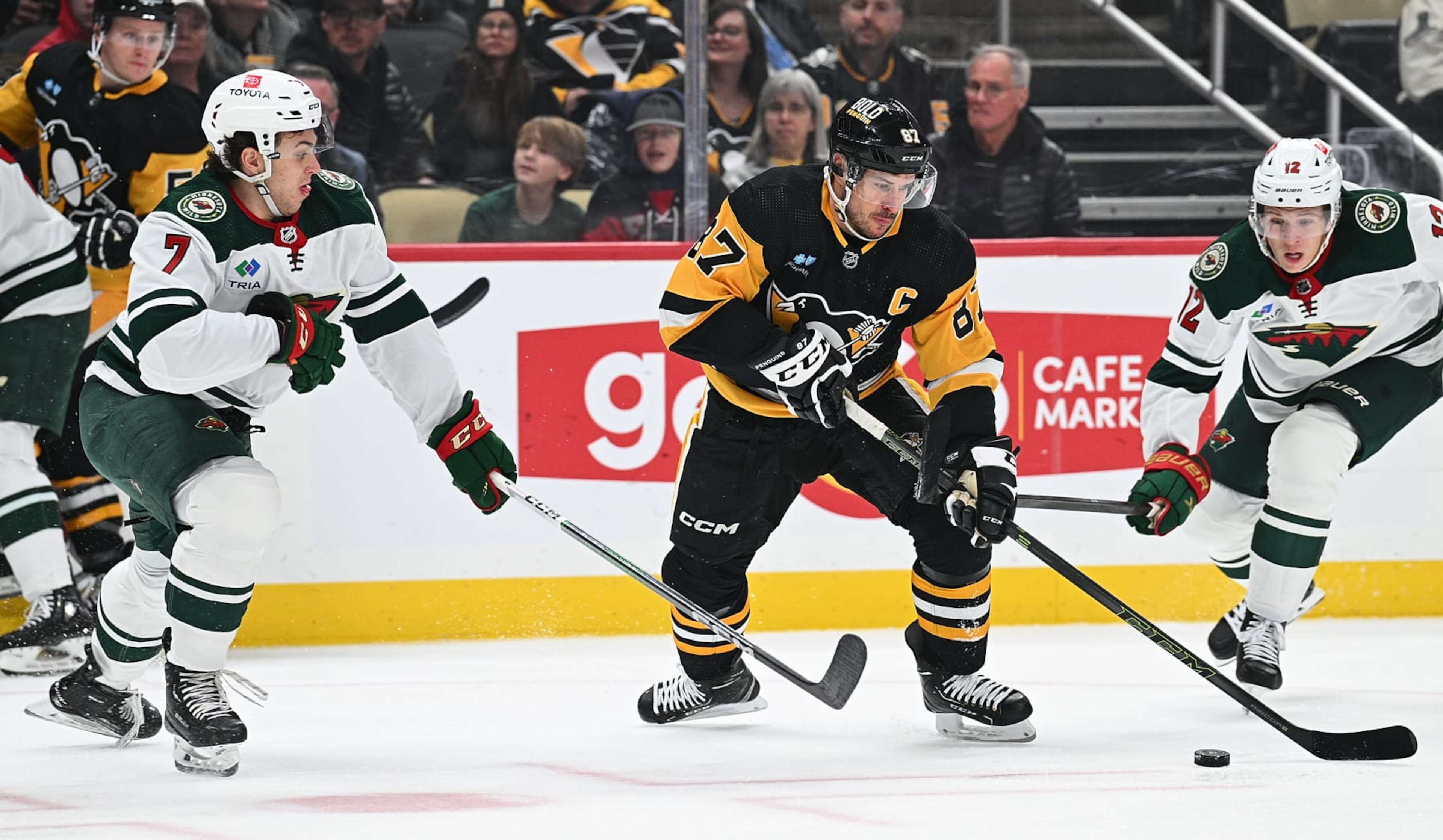 PITTSBURGH, PENNSYLVANIA - DECEMBER 18: Sidney Crosby #87 of the Pittsburgh Penguins skates with the puck against Brock Faber #7 of the Minnesota Wild in the first period during the game at PPG PAINTS Arena on December 18, 2023 in Pittsburgh, Pennsylvania. (Photo by Justin Berl/Getty Images) PITTSBURGH, PENNSYLVANIA - DECEMBER 18: Sidney Crosby #87 of the Pittsburgh Penguins skates with the puck against Brock Faber #7 of the Minnesota Wild in the first period during the game at PPG PAINTS Arena on December 18, 2023 in Pittsburgh, Pennsylvania. (Photo by Justin Berl/Getty Images)