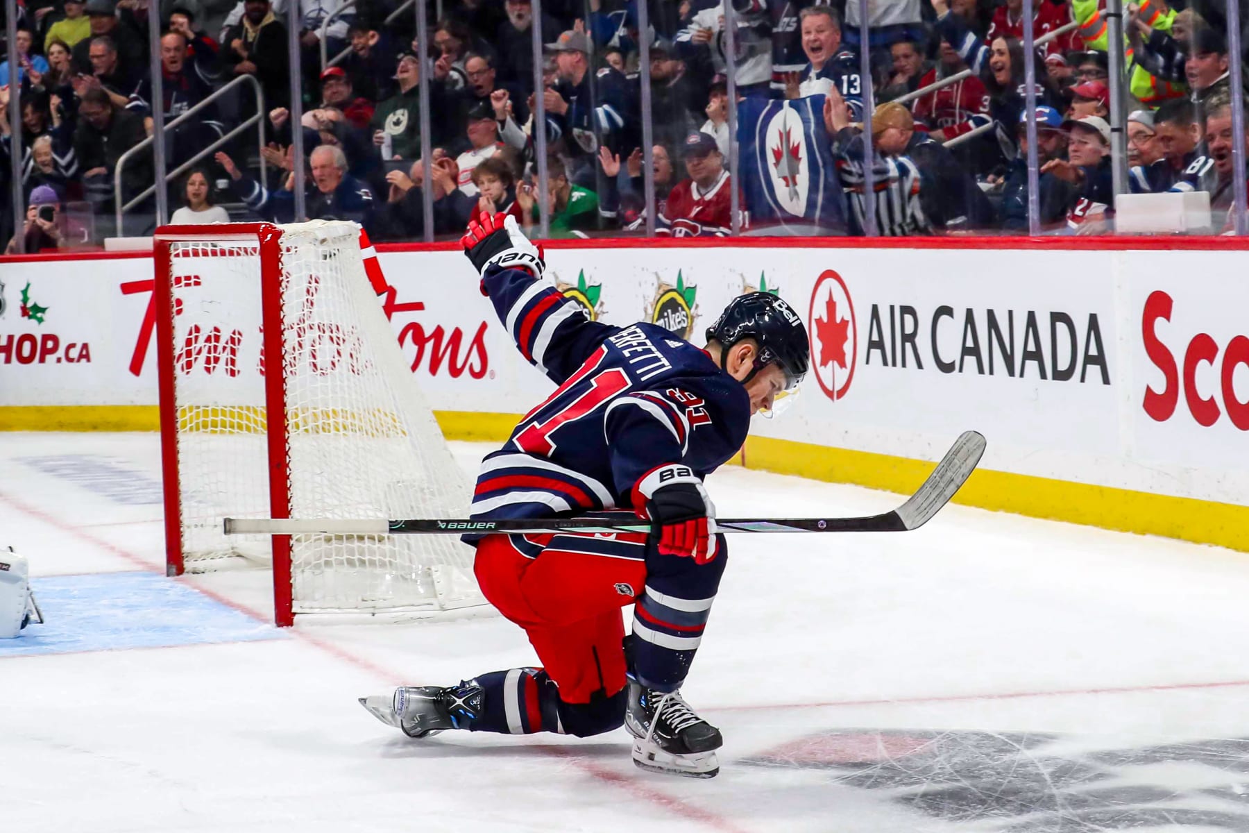 WINNIPEG, CANADA - DECEMBER 18: Cole Perfetti #91 of the Winnipeg Jets celebrates after scoring a third period goal against the Montreal Canadiens at the Canada Life Centre on December 18, 2023 in Winnipeg, Manitoba, Canada. (Photo by Darcy Finley/NHLI via Getty Images)
