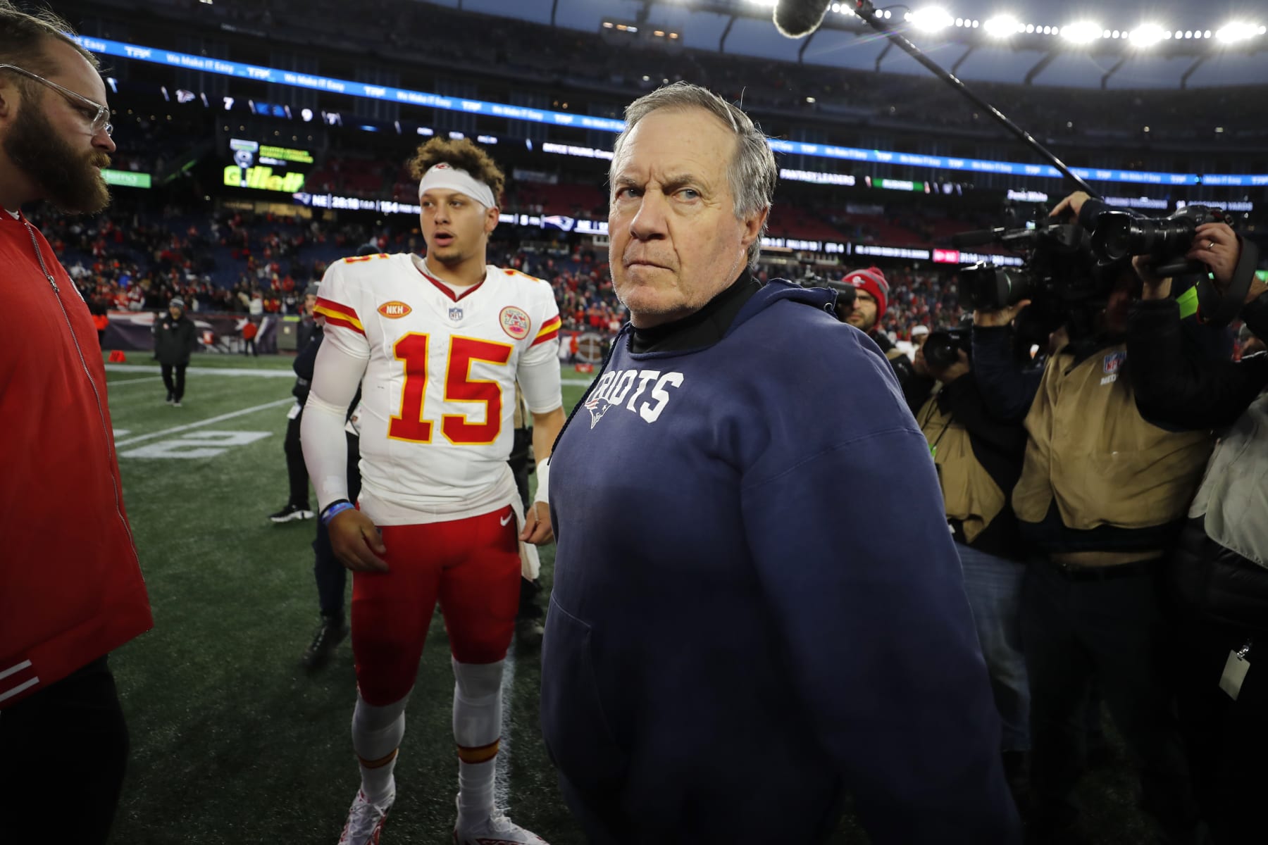 New England Patriots head coach Bill Belichick, center, steps off the field after greeting Kansas City Chiefs quarterback Patrick Mahomes (15) following an NFL football game, Sunday, Dec. 17, 2023, in Foxborough, Mass. (AP Photo/Michael Dwyer)