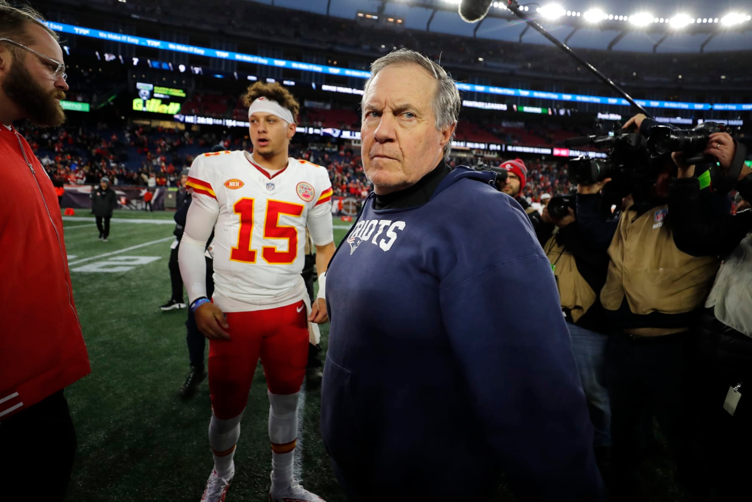 New England Patriots head coach Bill Belichick, center, steps off the field after greeting Kansas City Chiefs quarterback Patrick Mahomes (15) following an NFL football game, Sunday, Dec. 17, 2023, in Foxborough, Mass. (AP Photo/Michael Dwyer)