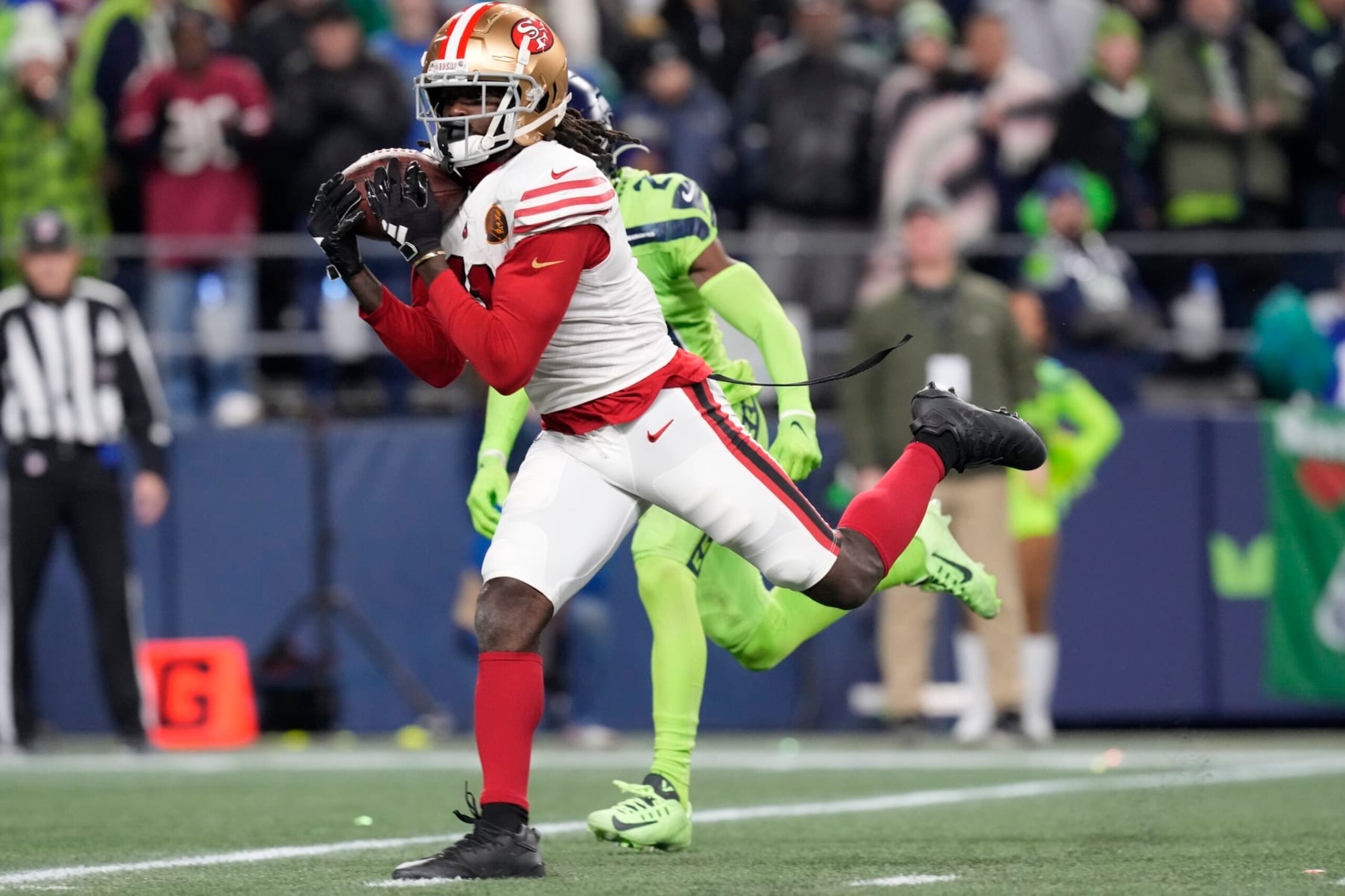 San Francisco 49ers wide receiver Brandon Aiyuk (11) catches a pass for a touchdown during an NFL football game against the Seattle Seahawks, Thursday, Nov. 23, 2023 in Seattle. The 49ers won 31-13. (AP Photo/Ben VanHouten)