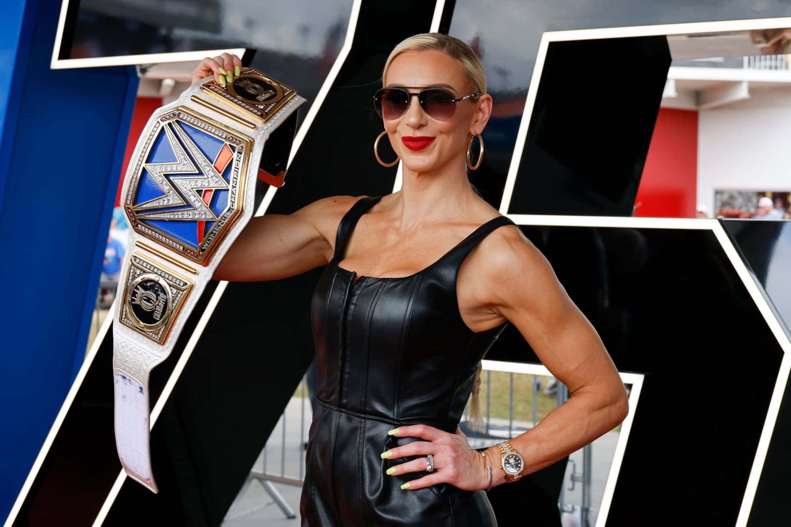 WWE Superstar Charlotte Flair shows off her championship wrestling belt as she poses for photographers during a red carpet event before the start of the NASCAR Daytona 500 auto race at Daytona International Speedway, Sunday, Feb. 19, 2023, in Daytona Beach, Fla. (AP Photo/Terry Renna) WWE Superstar Charlotte Flair shows off her championship wrestling belt as she poses for photographers during a red carpet event before the start of the NASCAR Daytona 500 auto race at Daytona International Speedway, Sunday, Feb. 19, 2023, in Daytona Beach, Fla. (AP Photo/Terry Renna)