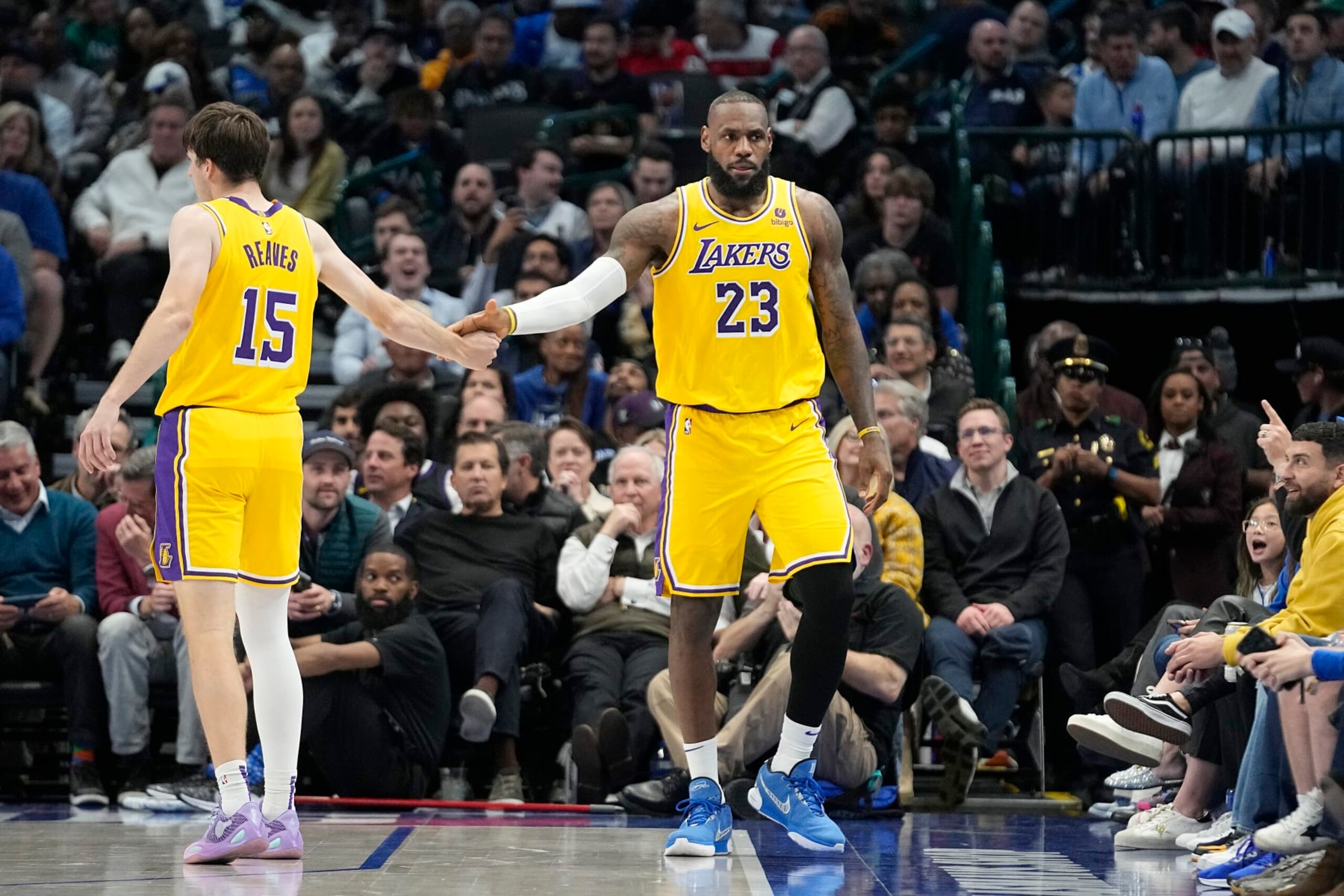 Los Angeles Lakers forward LeBron James gets a congrats from teammate Los Angeles Lakers guard Austin Reaves (15) during the second half of an NBA basketball game against the Dallas Mavericks in Dallas, Tuesday, Dec. 12, 2023. (AP Photo/LM Otero)
