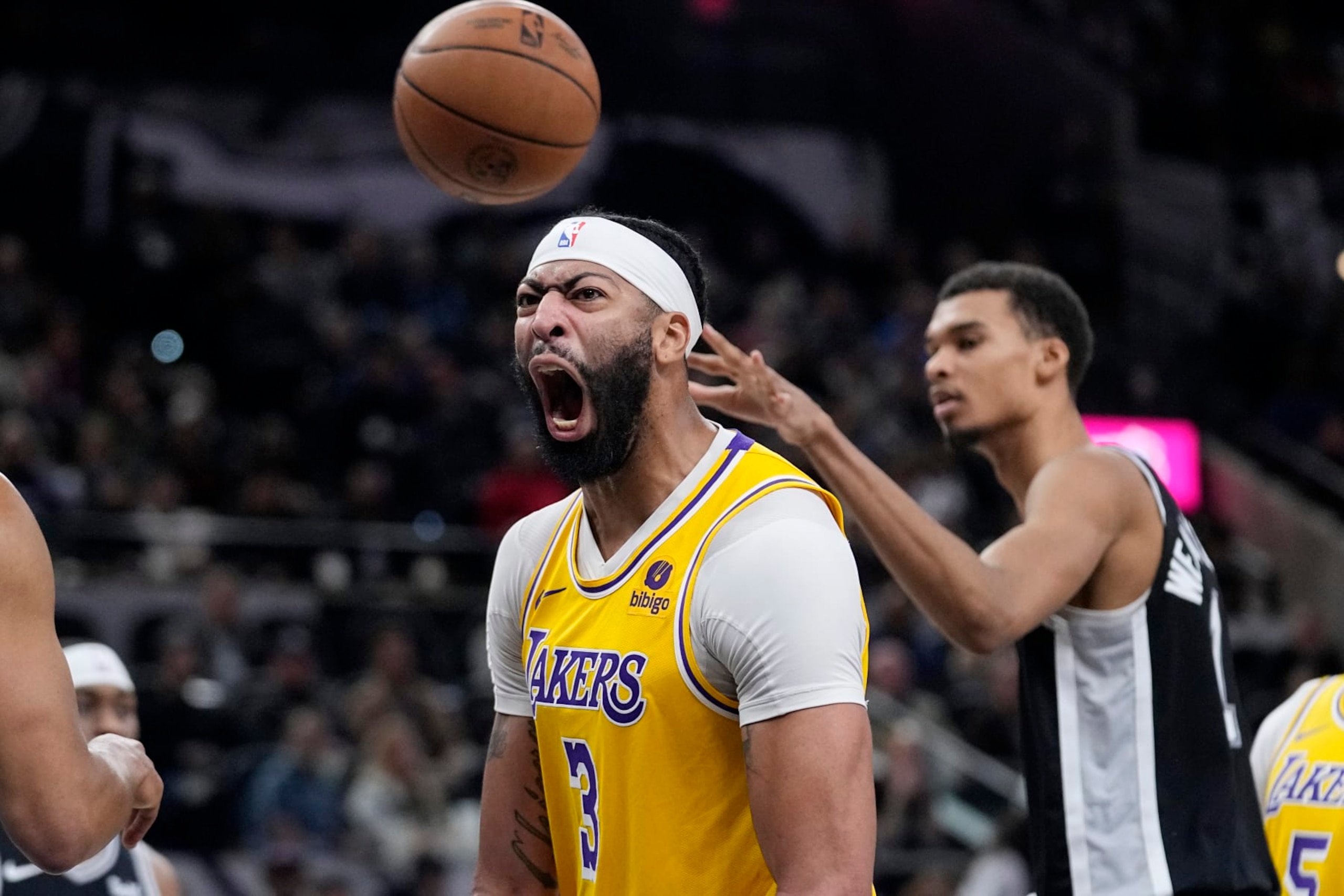 Los Angeles Lakers forward Anthony Davis (3) reacts after scoring over San Antonio Spurs center Victor Wembanyama (1) during the first half of an NBA basketball game in San Antonio, Wednesday, Dec. 13, 2023. (AP Photo/Eric Gay)