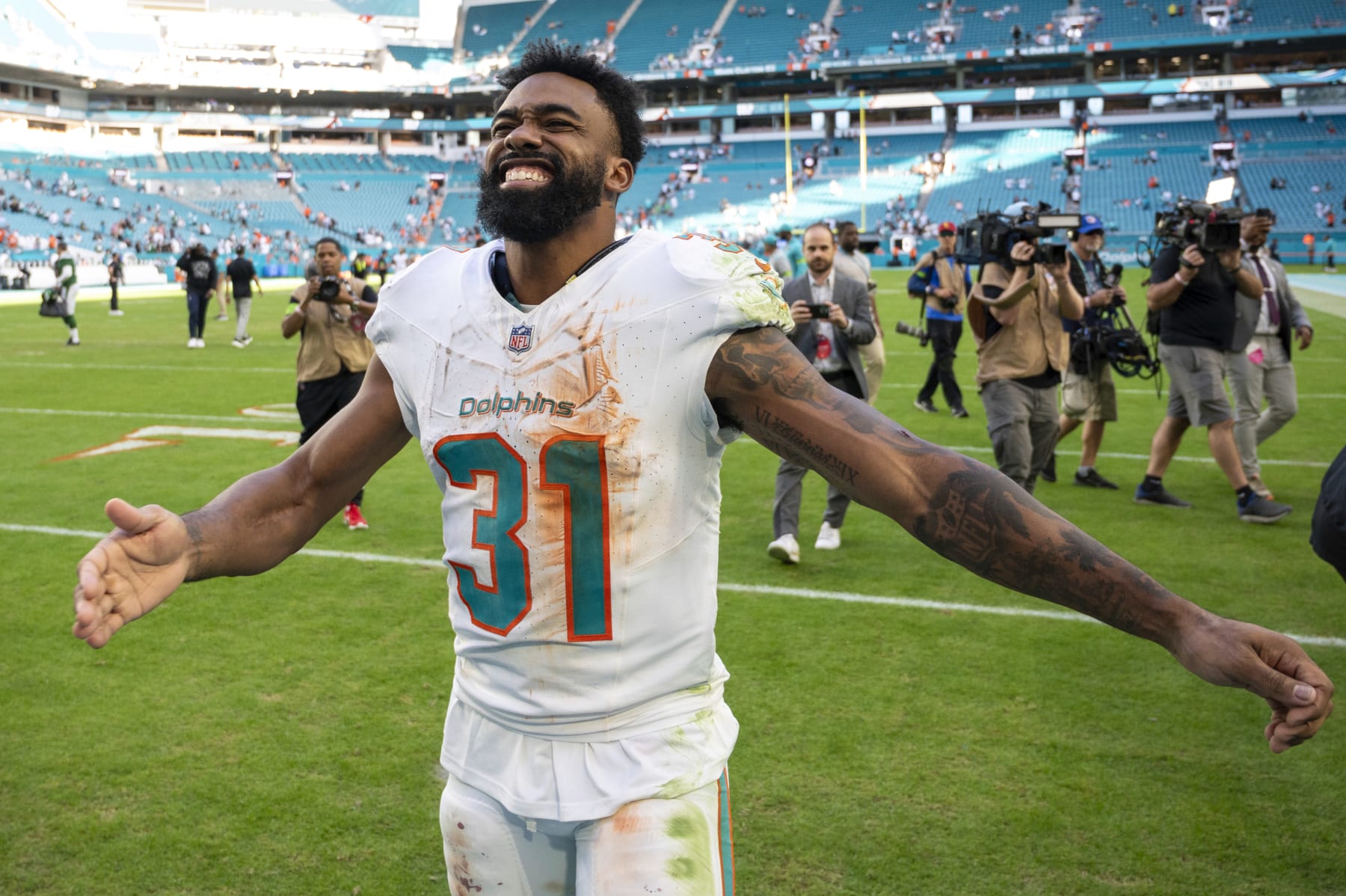 Miami Dolphins running back Raheem Mostert (31) smiles and gestures after the Miami Dolphins defeated the New York Jets 30-0 during an NFL football, Sunday, Dec 17, 2023, in Miami Gardens, Fla. (AP Photo/Doug Murray)