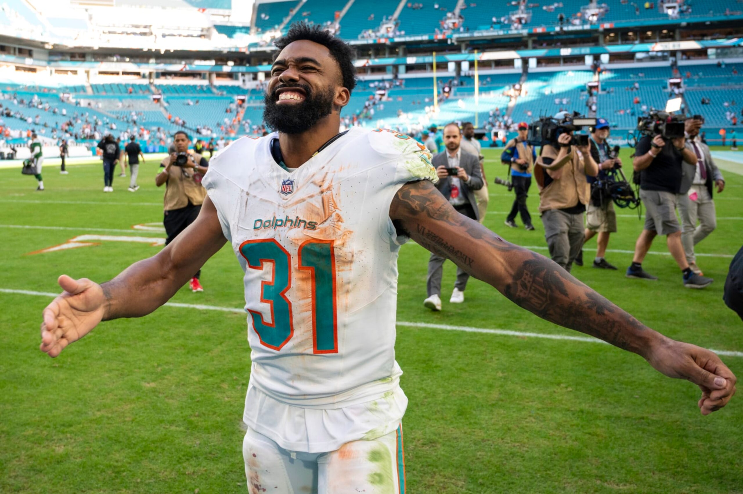 Miami Dolphins running back Raheem Mostert (31) smiles and gestures after the Miami Dolphins defeated the New York Jets 30-0 during an NFL football, Sunday, Dec 17, 2023, in Miami Gardens, Fla. (AP Photo/Doug Murray) Miami Dolphins running back Raheem Mostert (31) smiles and gestures after the Miami Dolphins defeated the New York Jets 30-0 during an NFL football, Sunday, Dec 17, 2023, in Miami Gardens, Fla. (AP Photo/Doug Murray)