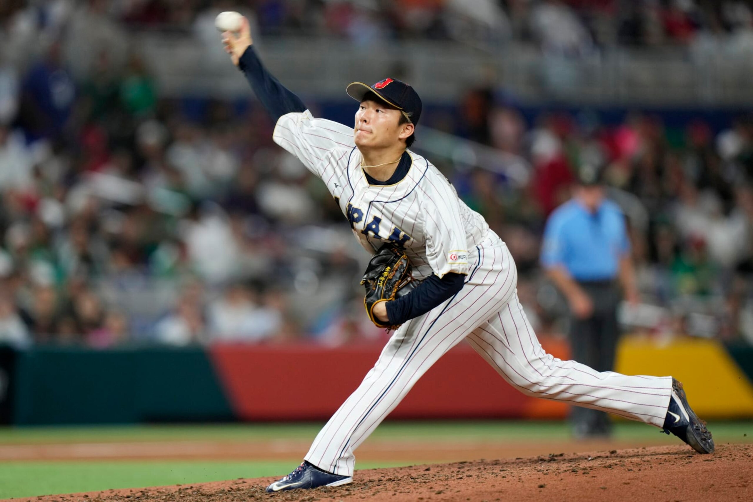 FILE - Japan's Yoshinobu Yamamoto delivers a pitch during the fifth inning of a World Baseball Classic game against Mexico on March 20, 2023, in Miami. Yamamoto already has a New York Yankees pinstripes with No. 18, the numeral prized by manager Japanese pitchers. “I gave him that jersey. It's his if he wants to keep it,” Yankees manager Aaron Boone said Thursday, Dec. 21, 2023. (AP Photo/Wilfredo Lee, File)