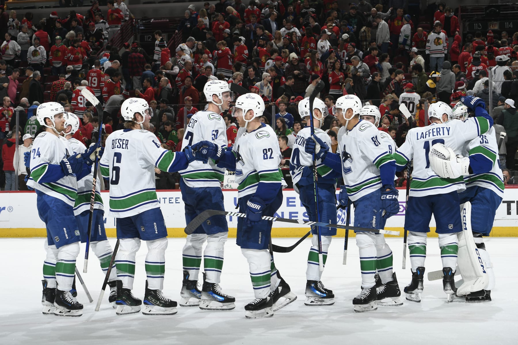 CHICAGO, ILLINOIS - DECEMBER 17: The Vancouver Canucks celebrate after defeating the Chicago Blackhawks 4-3 at the United Center on December 17, 2023 in Chicago, Illinois. (Photo by Bill Smith/NHLI via Getty Images)
