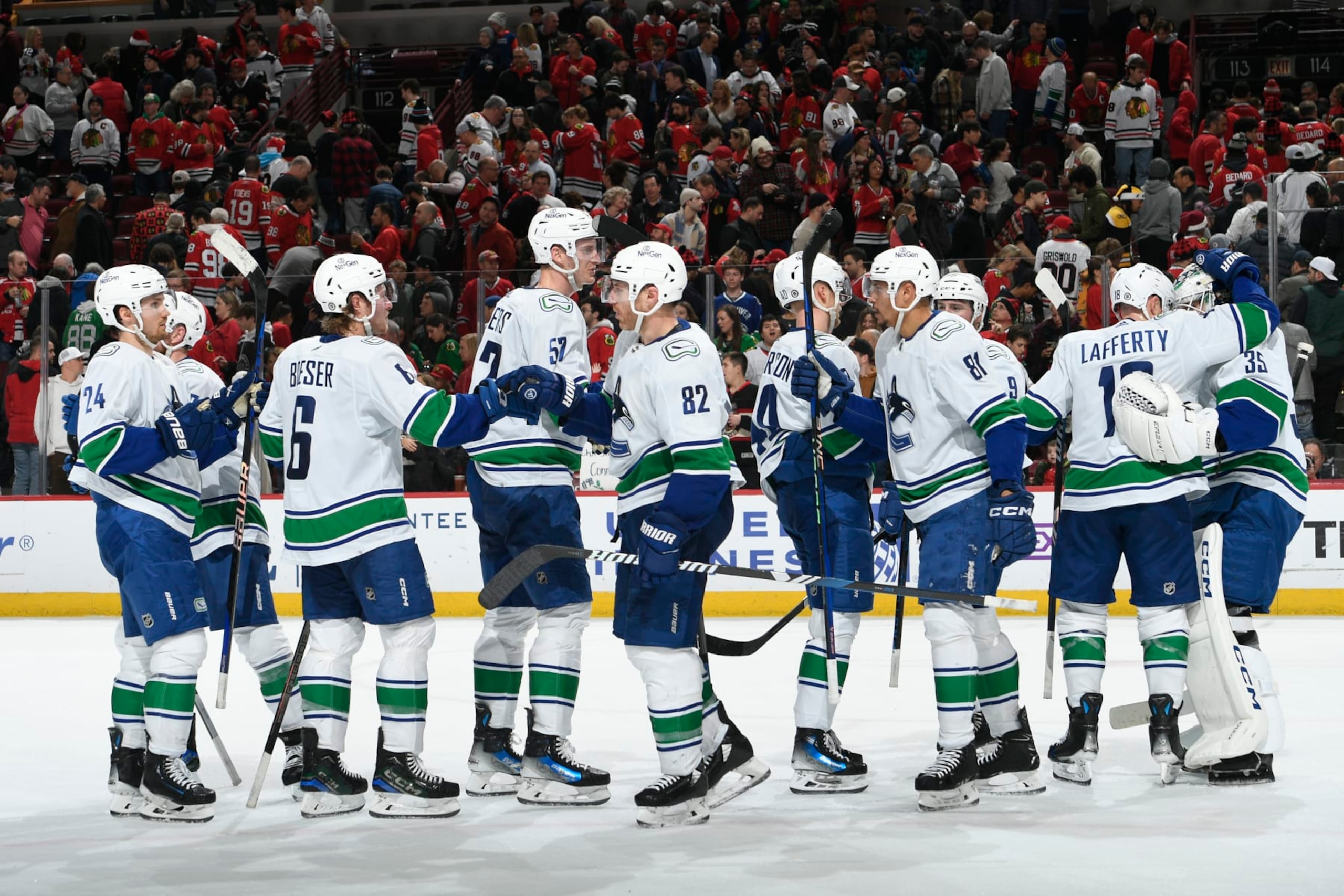 CHICAGO, ILLINOIS - DECEMBER 17: The Vancouver Canucks celebrate after defeating the Chicago Blackhawks 4-3 at the United Center on December 17, 2023 in Chicago, Illinois. (Photo by Bill Smith/NHLI via Getty Images)