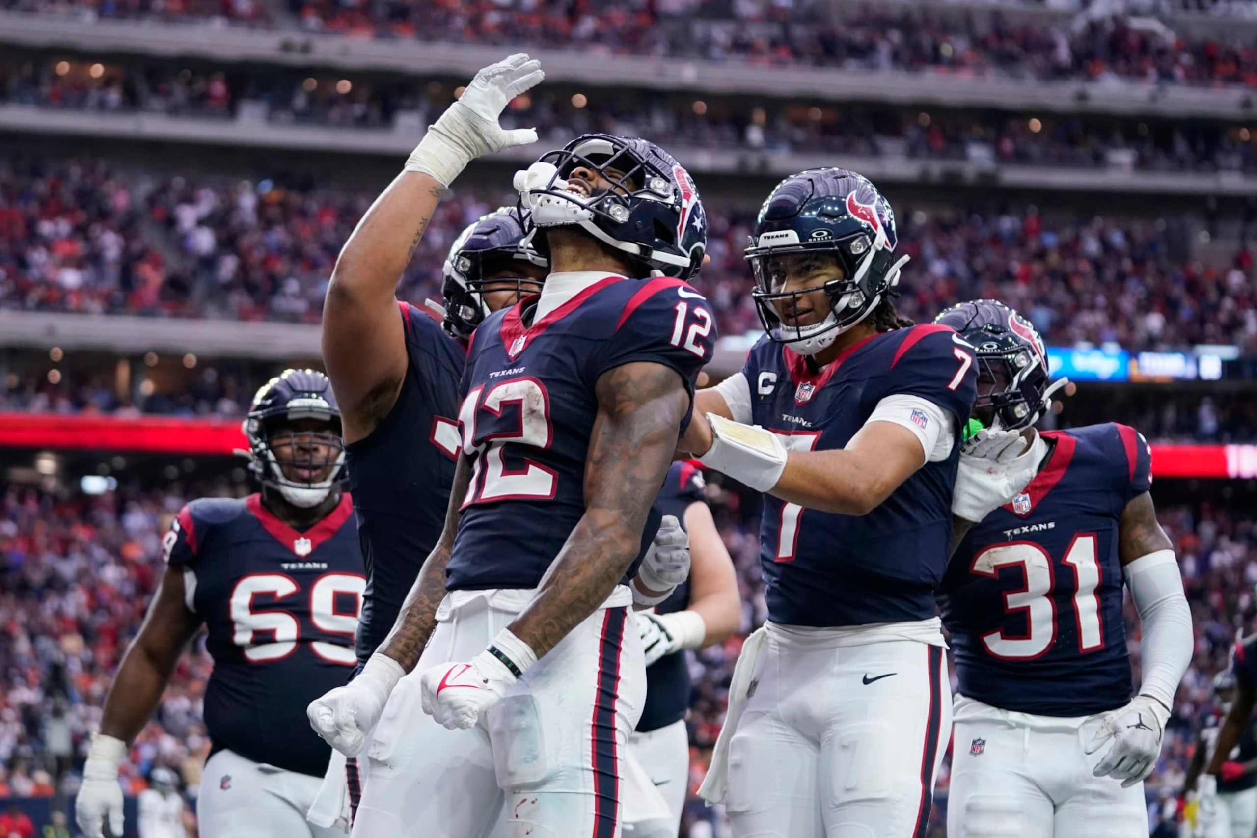 Houston Texans wide receiver Nico Collins (12) celebrates after catching a touchdown pass against the Denver Broncos in the second half of an NFL football game Sunday, Dec. 3, 2023, in Houston. (AP Photo/Eric Christian Smith)