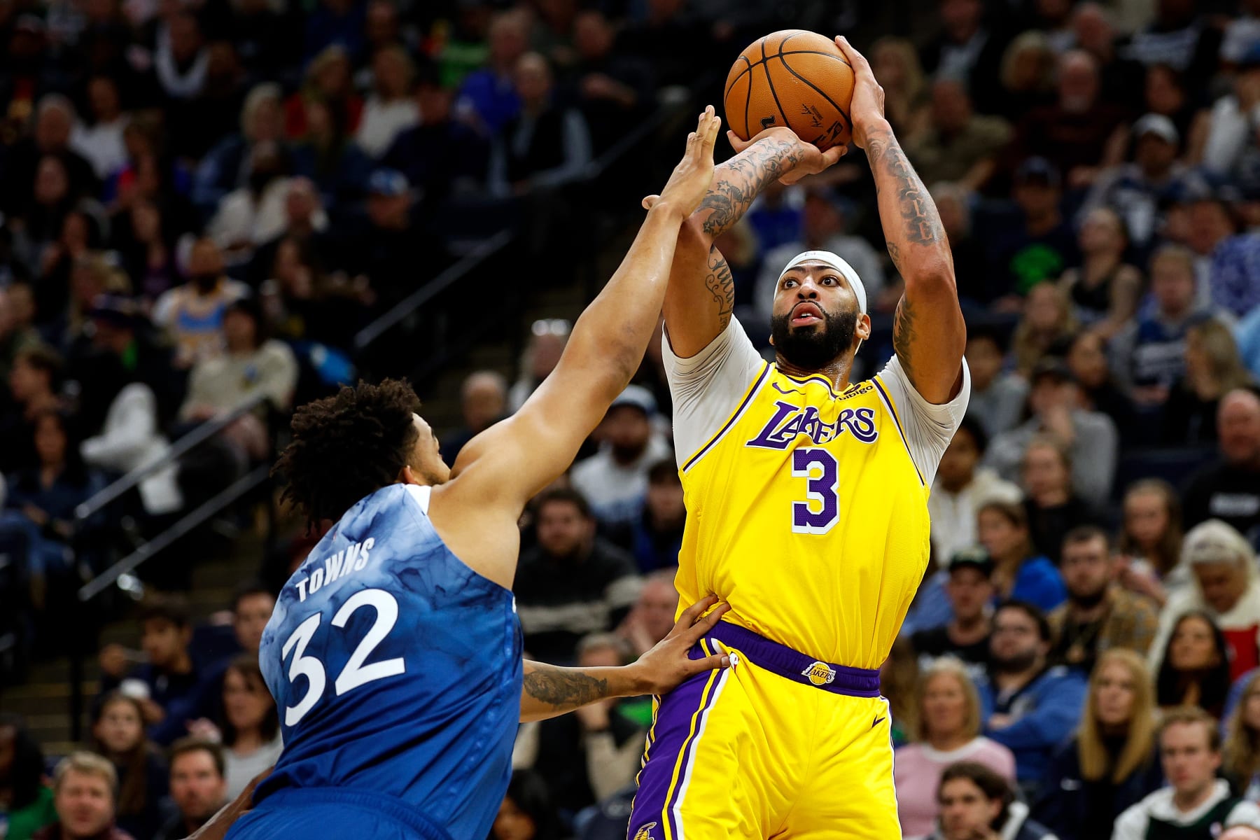 MINNEAPOLIS, MINNESOTA - DECEMBER 21: Anthony Davis #3 of the Los Angeles Lakers shoots the ball while Karl-Anthony Towns #32 of the Minnesota Timberwolves defends in the third quarter at Target Center on December 21, 2023 in Minneapolis, Minnesota. The Timberwolves defeated the Lakers 118-111. NOTE TO USER: User expressly acknowledges and agrees that, by downloading and or using this photograph, User is consenting to the terms and conditions of the Getty Images License Agreement. (Photo by David Berding/Getty Images)
