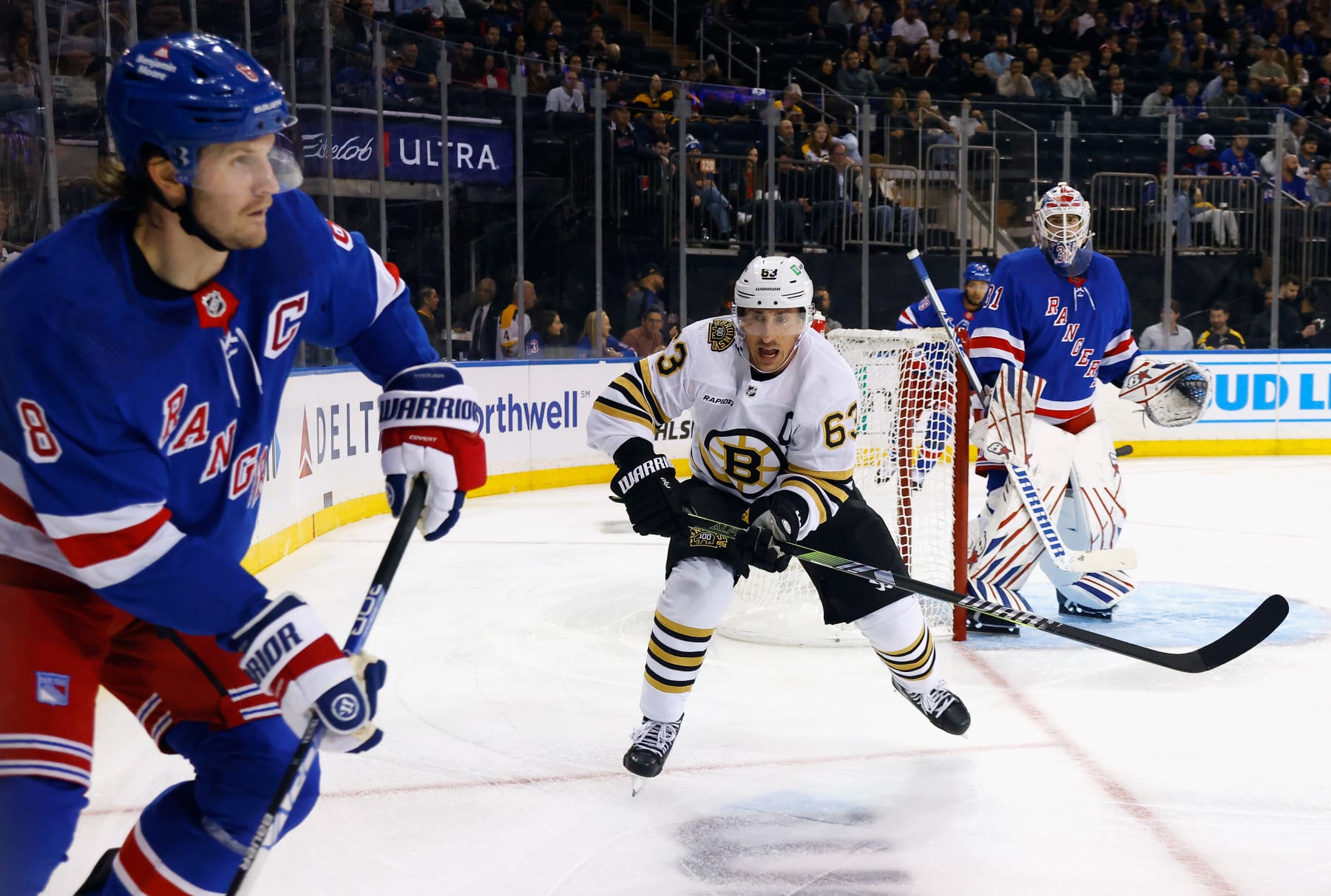 New York Rangers captain Jacob Trouba (left) and Boston Bruins captain Brad Marchand. 