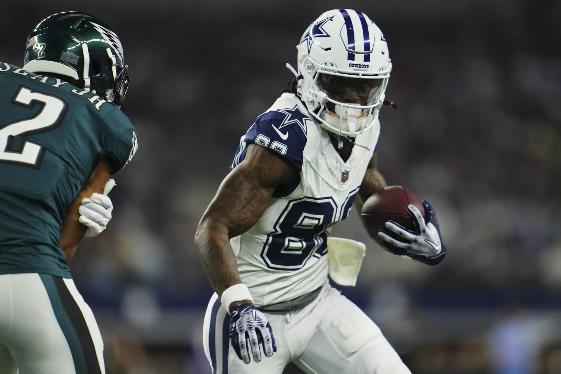 ARLINGTON, TX - DECEMBER 10: CeeDee Lamb #88 of the Dallas Cowboys runs with the ball against the Philadelphia Eagles during the first half at AT&T Stadium on December 10, 2023 in Arlington, Texas. (Photo by Cooper Neill/Getty Images)