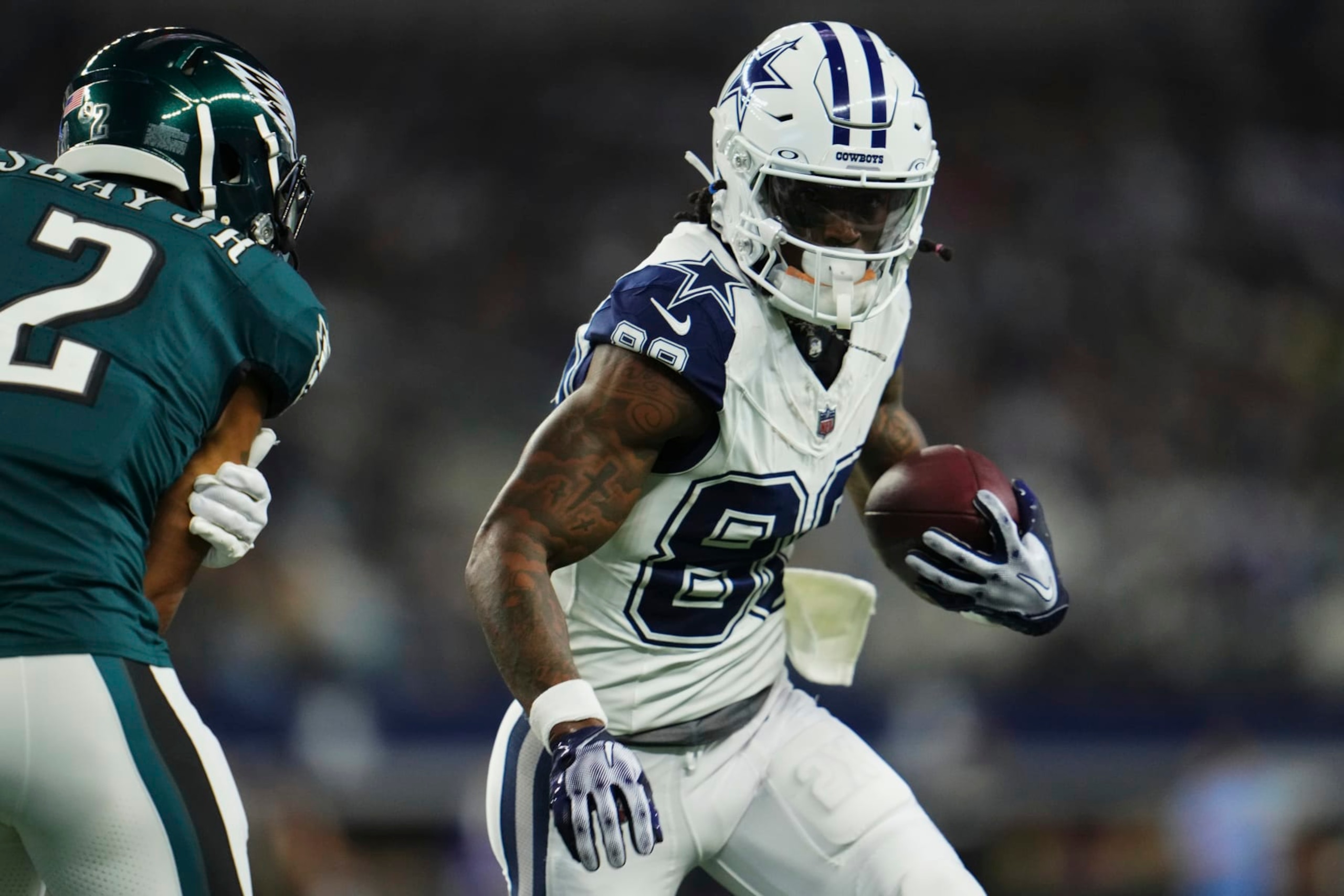 ARLINGTON, TX - DECEMBER 10: CeeDee Lamb #88 of the Dallas Cowboys runs with the ball against the Philadelphia Eagles during the first half at AT&T Stadium on December 10, 2023 in Arlington, Texas. (Photo by Cooper Neill/Getty Images)