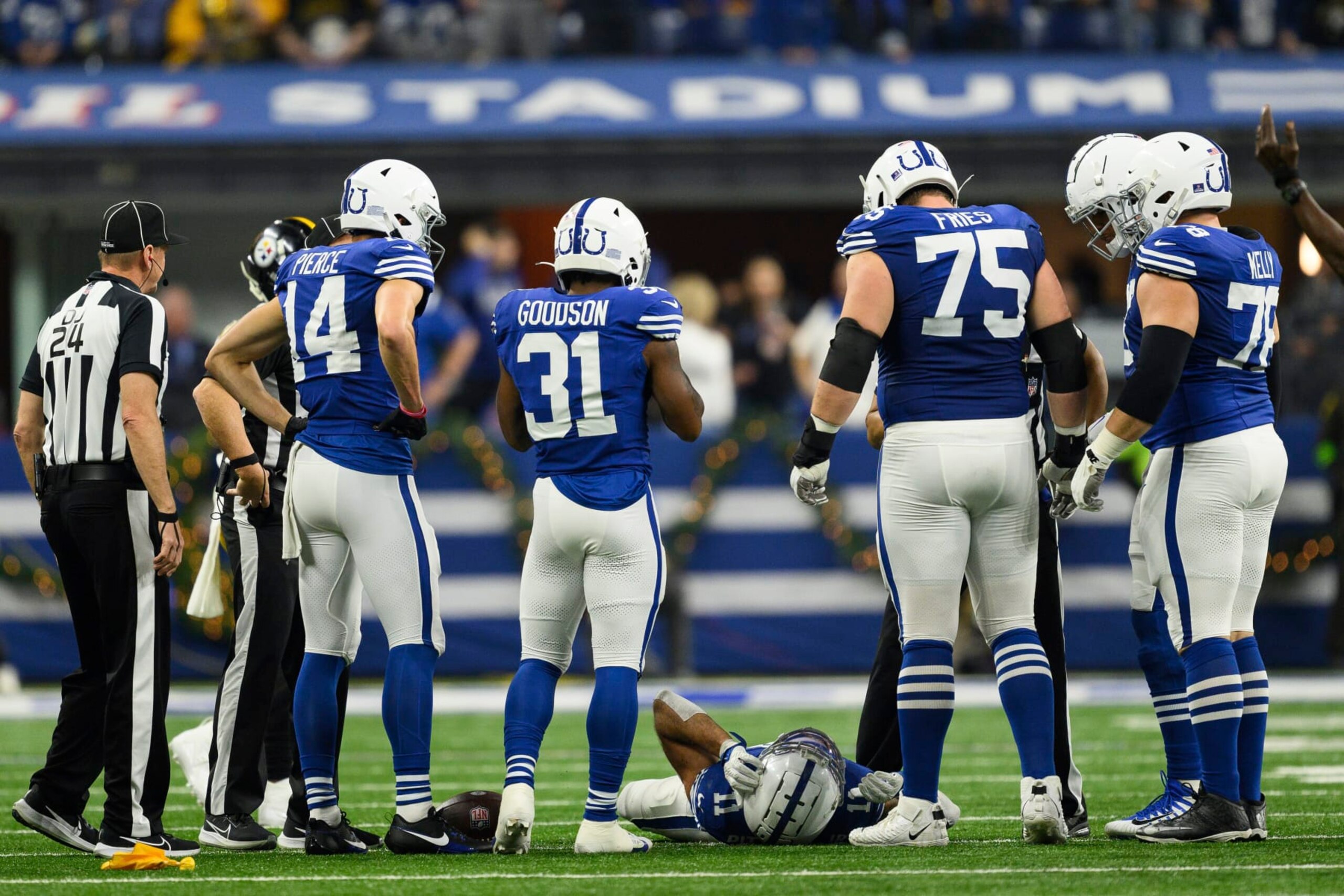 Indianapolis Colts wide receiver Michael Pittman Jr. (11) lays on the field after getting injured as teammates huddle around during an NFL football game against the Pittsburgh Steelers, Saturday, Dec. 16, 2023, in Indianapolis. (AP Photo/Zach Bolinger)