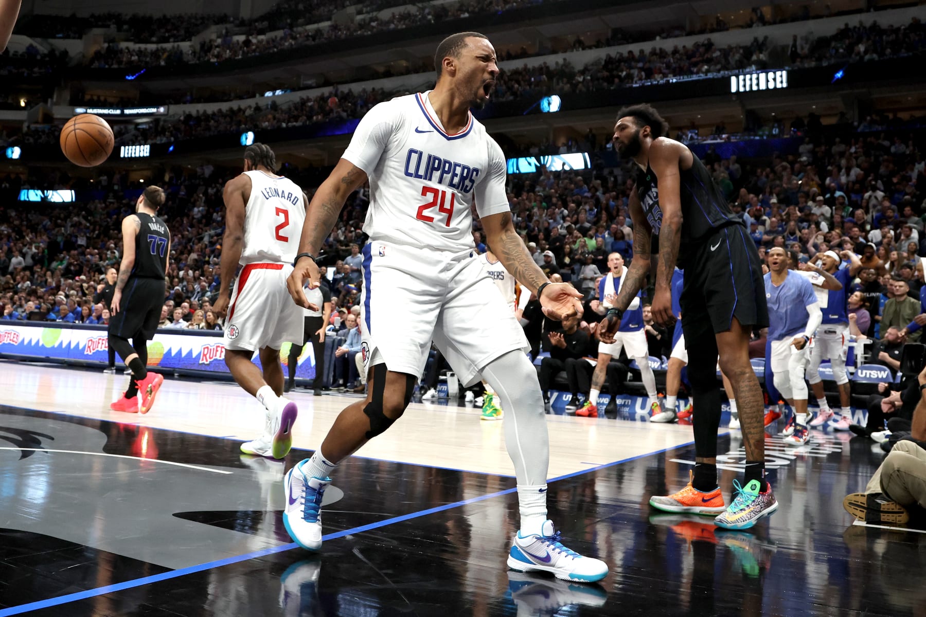 DALLAS, TEXAS - DECEMBER 20: Norman Powell #24 of the LA Clippers reacts after making a basket in the second half against the Dallas Mavericks at American Airlines Center on December 20, 2023 in Dallas, Texas. NOTE TO USER: User expressly acknowledges and agrees that, by downloading and or using this photograph, User is consenting to the terms and conditions of the Getty Images License Agreement. (Photo by Tim Heitman/Getty Images)