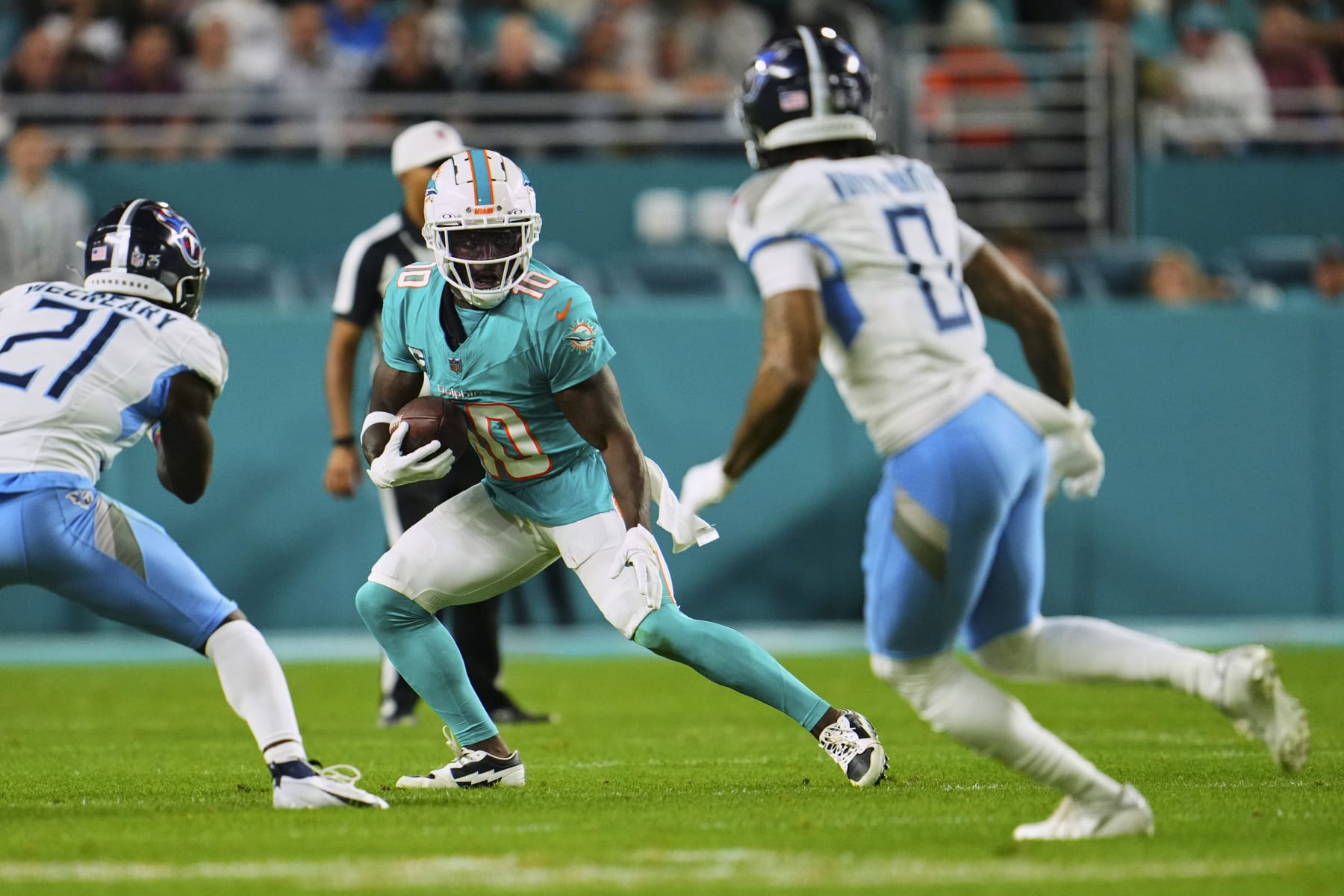 MIAMI GARDENS, FL - DECEMBER 11: Tyreek Hill #10 of the Miami Dolphins carries the ball against the Tennessee Titans during the first half at Hard Rock Stadium on December 11, 2023 in Miami Gardens, Florida. (Photo by Cooper Neill/Getty Images)
