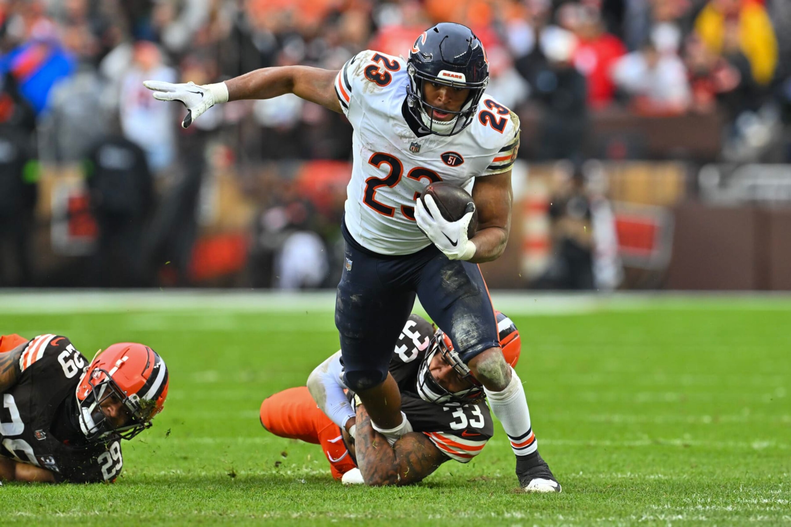 CLEVELAND, OHIO - DECEMBER 17: Roschon Johnson #23 of the Chicago Bears runs with the ball as Ronnie Hickman #33 of the Cleveland Browns looks to make a tackle during the second quarter at Cleveland Browns Stadium on December 17, 2023 in Cleveland, Ohio. (Photo by Jason Miller/Getty Images)