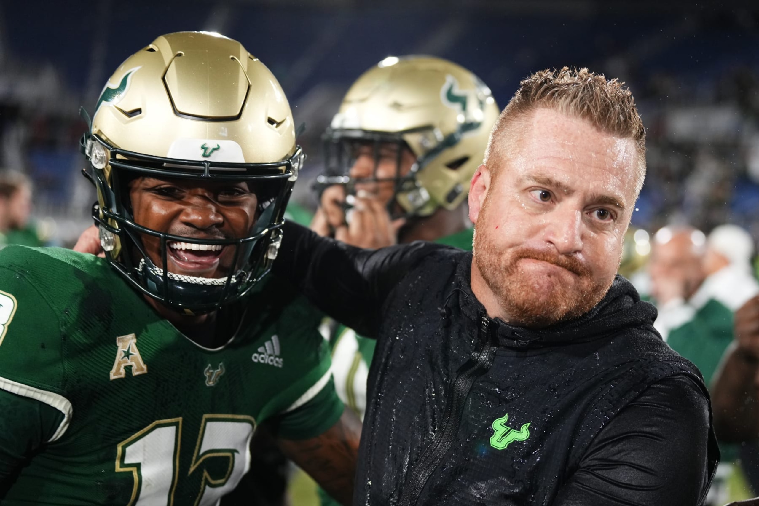 BOCA RATON, FLORIDA - DECEMBER 21: Israel Carter #13 of the South Florida Bulls and head coach Alex Golesh celebrate after defeating the Syracuse Orange in the RoofClaim.com Boca Raton Bowl game at FAU Stadium on December 21, 2023 in Boca Raton, Florida. (Photo by Rich Storry/Getty Images) BOCA RATON, FLORIDA - DECEMBER 21: Israel Carter #13 of the South Florida Bulls and head coach Alex Golesh celebrate after defeating the Syracuse Orange in the RoofClaim.com Boca Raton Bowl game at FAU Stadium on December 21, 2023 in Boca Raton, Florida. (Photo by Rich Storry/Getty Images)