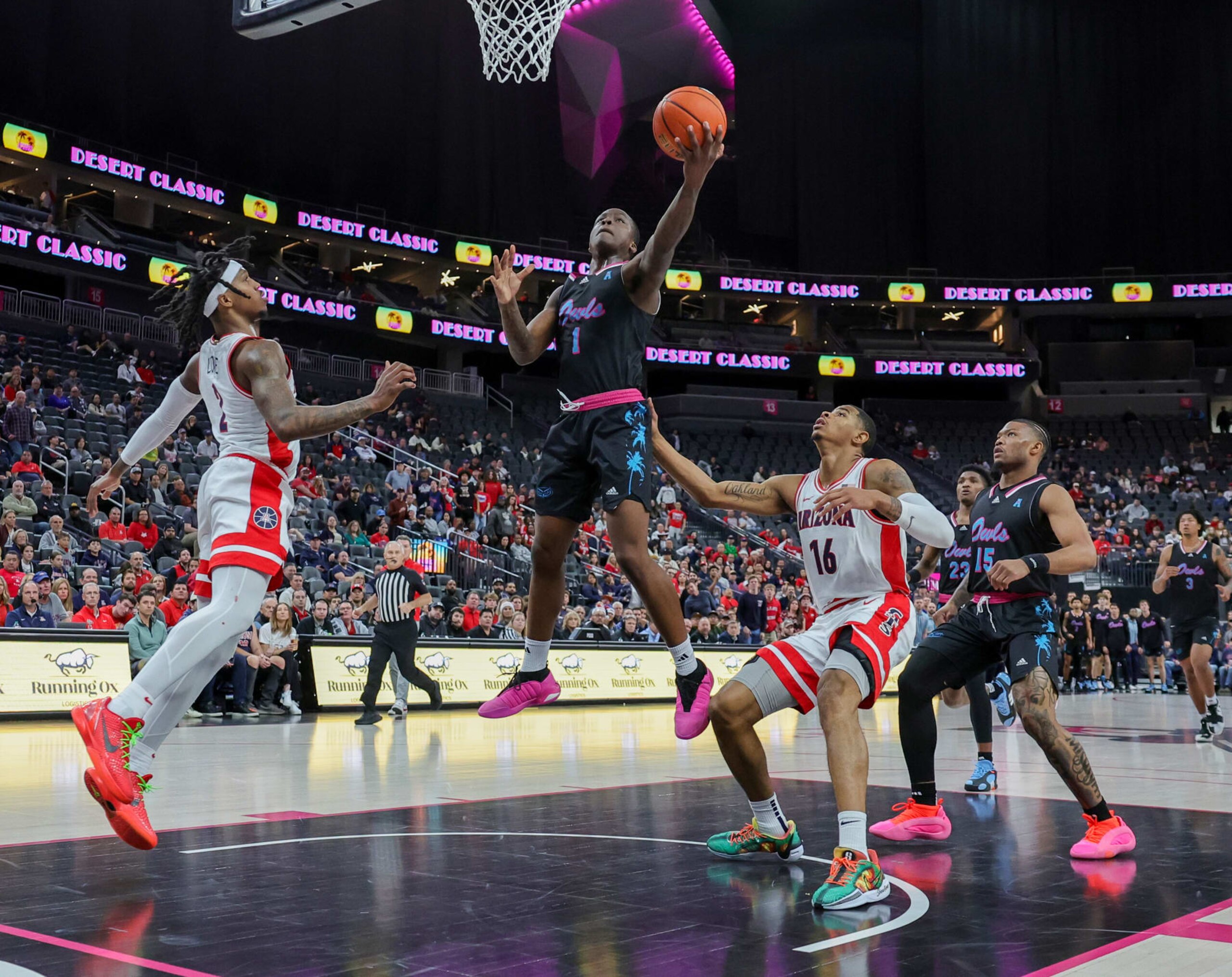LAS VEGAS, NEVADA - DECEMBER 23: Johnell Davis #1 of the Florida Atlantic Owls shoots against Caleb Love #2 and Keshad Johnson #16 of the Arizona Wildcats in the first half of the Desert Classic at T-Mobile Arena on December 23, 2023 in Las Vegas, Nevada. (Photo by Ethan Miller/Getty Images) LAS VEGAS, NEVADA - DECEMBER 23: Johnell Davis #1 of the Florida Atlantic Owls shoots against Caleb Love #2 and Keshad Johnson #16 of the Arizona Wildcats in the first half of the Desert Classic at T-Mobile Arena on December 23, 2023 in Las Vegas, Nevada. (Photo by Ethan Miller/Getty Images)