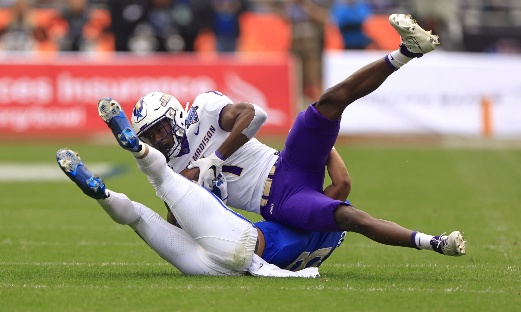 FORT WORTH, TX - DECEMBER 23: Wide receiver Reggie Brown #1 of the James Madison Dukes catches a pass for a first down against the Air Force Falcons in the first half of the Lockheed Martin Armed Forces Bowl at Amon G. Carter Stadium on December 23, 2023 in Fort Worth, Texas. (Photo by Ron Jenkins/Getty Images)
