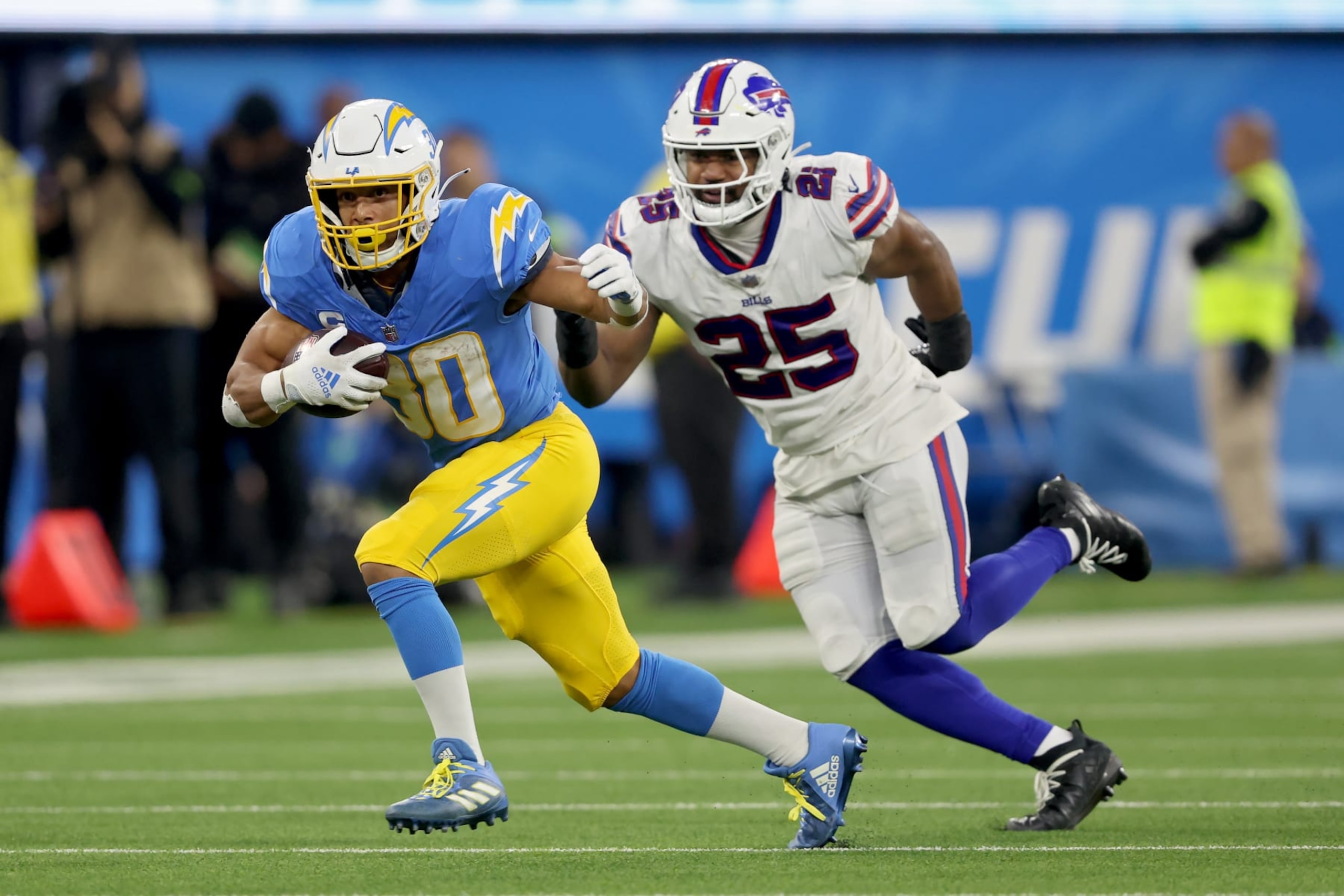 INGLEWOOD, CALIFORNIA - DECEMBER 23: Austin Ekeler #30 of the Los Angeles Chargers runs with the ball while being chased by Tyrel Dodson #25 of the Buffalo Bills in the fourth quarter at SoFi Stadium on December 23, 2023 in Inglewood, California. (Photo by Sean M. Haffey/Getty Images) INGLEWOOD, CALIFORNIA - DECEMBER 23: Austin Ekeler #30 of the Los Angeles Chargers runs with the ball while being chased by Tyrel Dodson #25 of the Buffalo Bills in the fourth quarter at SoFi Stadium on December 23, 2023 in Inglewood, California. (Photo by Sean M. Haffey/Getty Images)