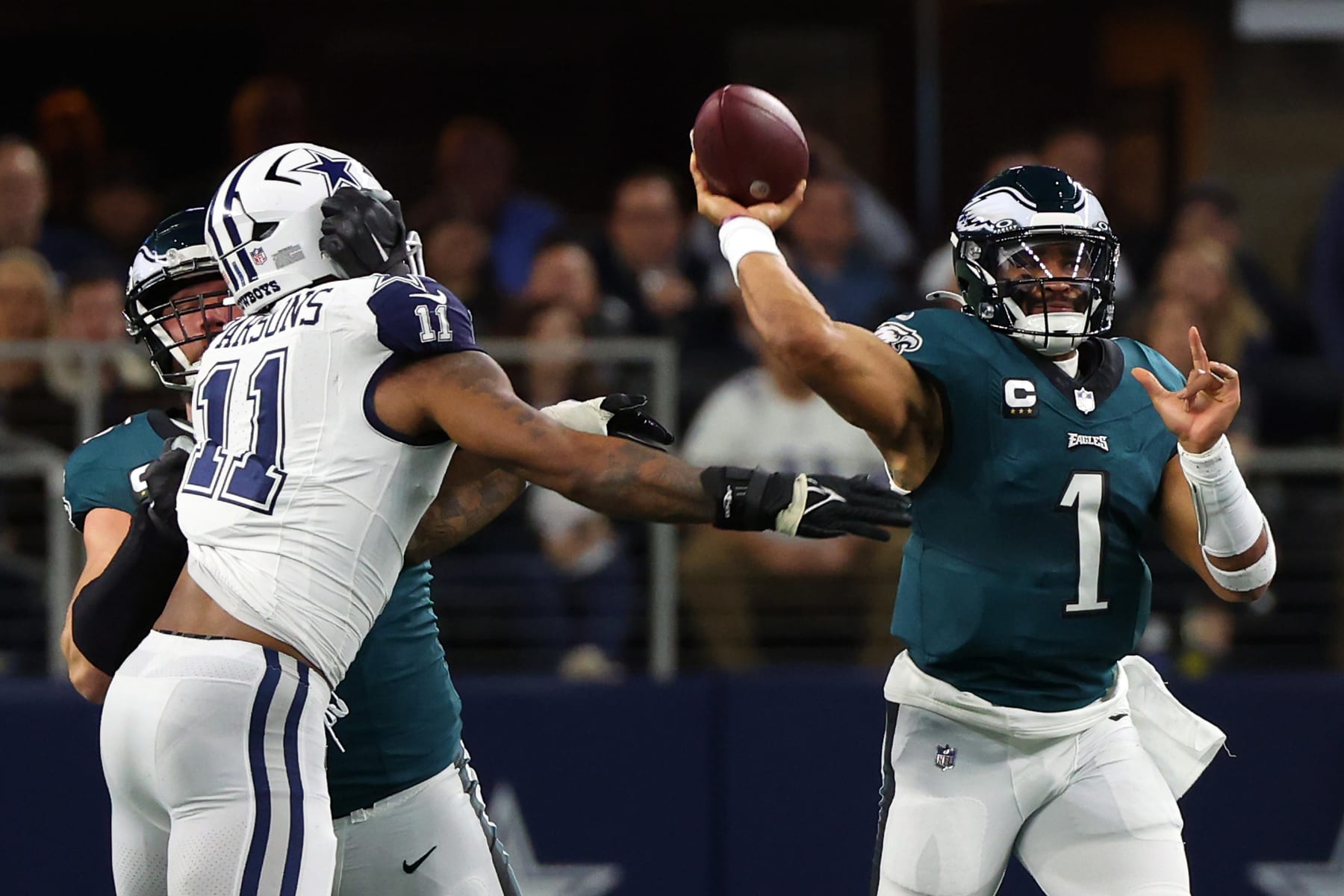 ARLINGTON, TEXAS - DECEMBER 10: Jalen Hurts #1 of the Philadelphia Eagles passes as Micah Parsons #11 of the Dallas Cowboys closes in at AT&T Stadium on December 10, 2023 in Arlington, Texas. (Photo by Richard Rodriguez/Getty Images)