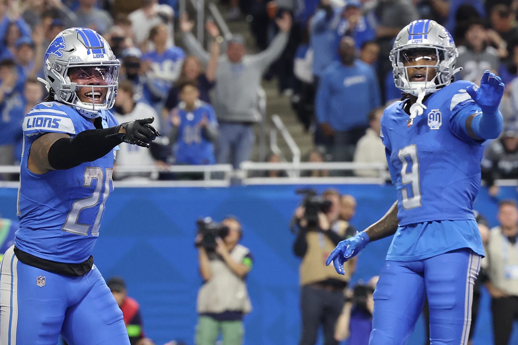 DETROIT, MICHIGAN - DECEMBER 16: Jahmyr Gibbs #26 of the Detroit Lions celebrates his touchdown with Jameson Williams #9 during the second quarter against the Denver Broncos at Ford Field on December 16, 2023 in Detroit, Michigan. (Photo by Rey Del Rio/Getty Images)