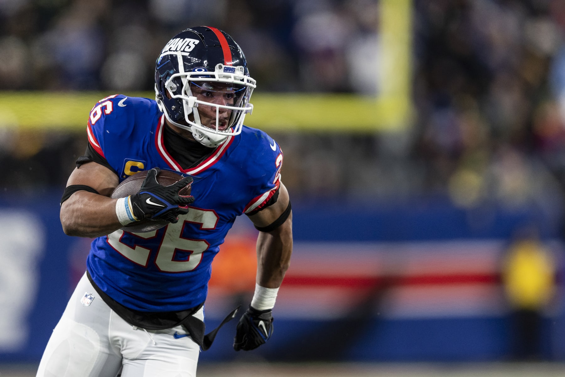 EAST RUTHERFORD, NEW JERSEY - DECEMBER 11: Saquon Barkley #26 of the New York Giants runs with the ball during an NFL football game between the New York Giants and the Green Bay Packers at MetLife Stadium on December 11, 2023 in East Rutherford, New Jersey. (Photo by Michael Owens/Getty Images)