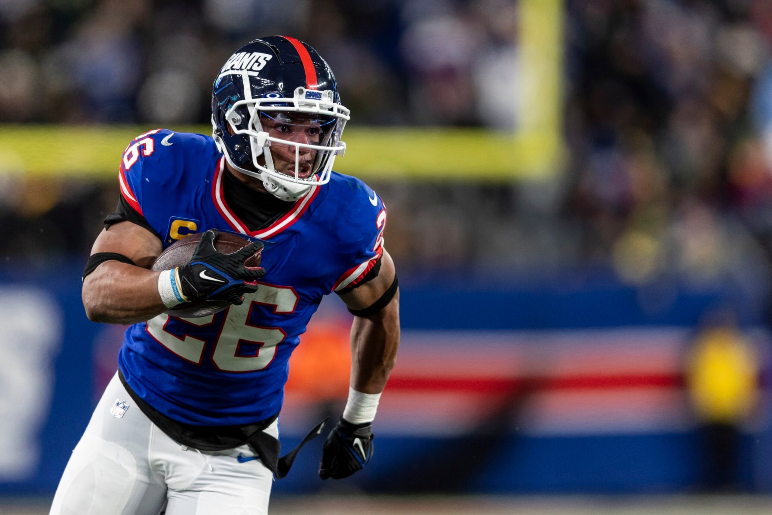 EAST RUTHERFORD, NEW JERSEY - DECEMBER 11: Saquon Barkley #26 of the New York Giants runs with the ball during an NFL football game between the New York Giants and the Green Bay Packers at MetLife Stadium on December 11, 2023 in East Rutherford, New Jersey. (Photo by Michael Owens/Getty Images) EAST RUTHERFORD, NEW JERSEY - DECEMBER 11: Saquon Barkley #26 of the New York Giants runs with the ball during an NFL football game between the New York Giants and the Green Bay Packers at MetLife Stadium on December 11, 2023 in East Rutherford, New Jersey. (Photo by Michael Owens/Getty Images)