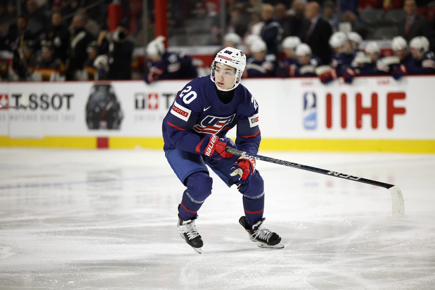MONCTON, NB - JANUARY 02:  Lane Hutson #20 Of Team USA skates for the puck against Team Germany in the third period in a quarterfinal game of the 2023 IIHF World Junior Championship at Avenir Centre on January 2, 2023 in Moncton, Canada. (Photo by Dale Preston/Getty Images)