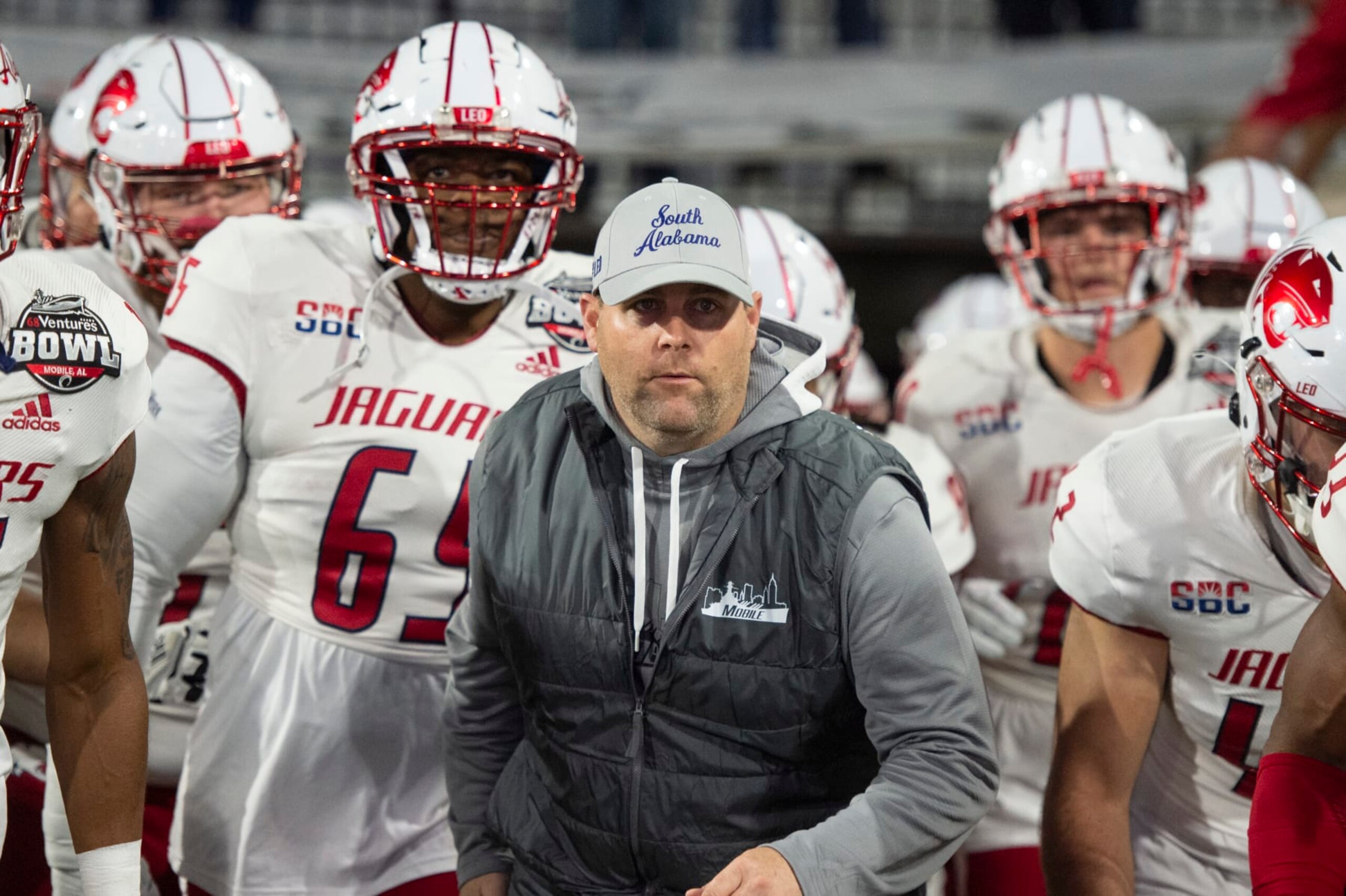 MOBILE, ALABAMA - DECEMBER 23: Head coach Kane Wommack of the South Alabama Jaguars leads his team on to the field prior to their game against the Eastern Michigan Eagles in the 68 Ventures Bowl at Hancock Whitney Stadium on December 23, 2023 in Mobile, Alabama. (Photo by Michael Chang/Getty Images)