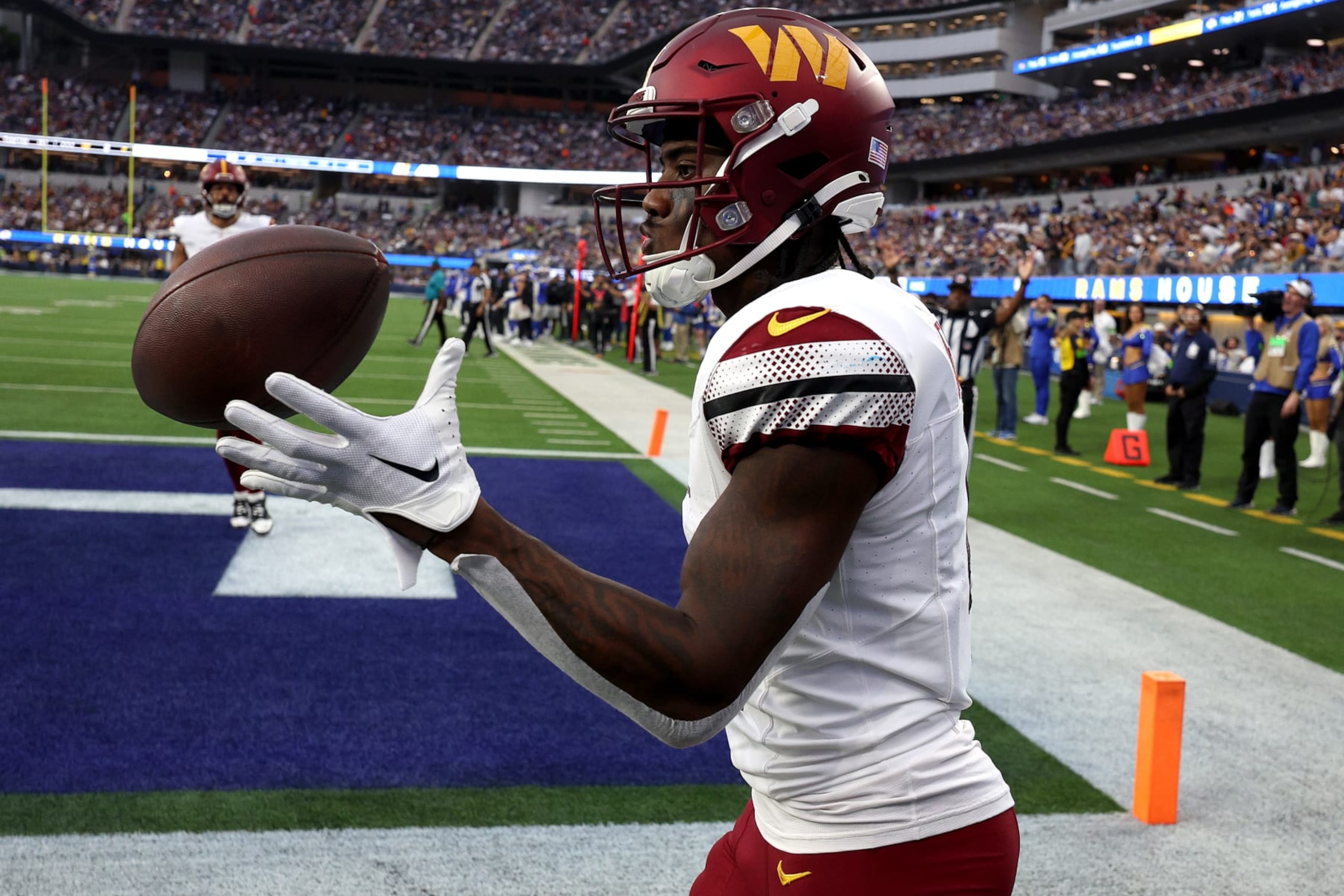 INGLEWOOD, CALIFORNIA - DECEMBER 17: Curtis Samuel #4 of the Washington Commanders reacts after catching a touchdown pass during the second half of the game against the Los Angeles Rams at SoFi Stadium on December 17, 2023 in Inglewood, California. (Photo by Harry How/Getty Images)