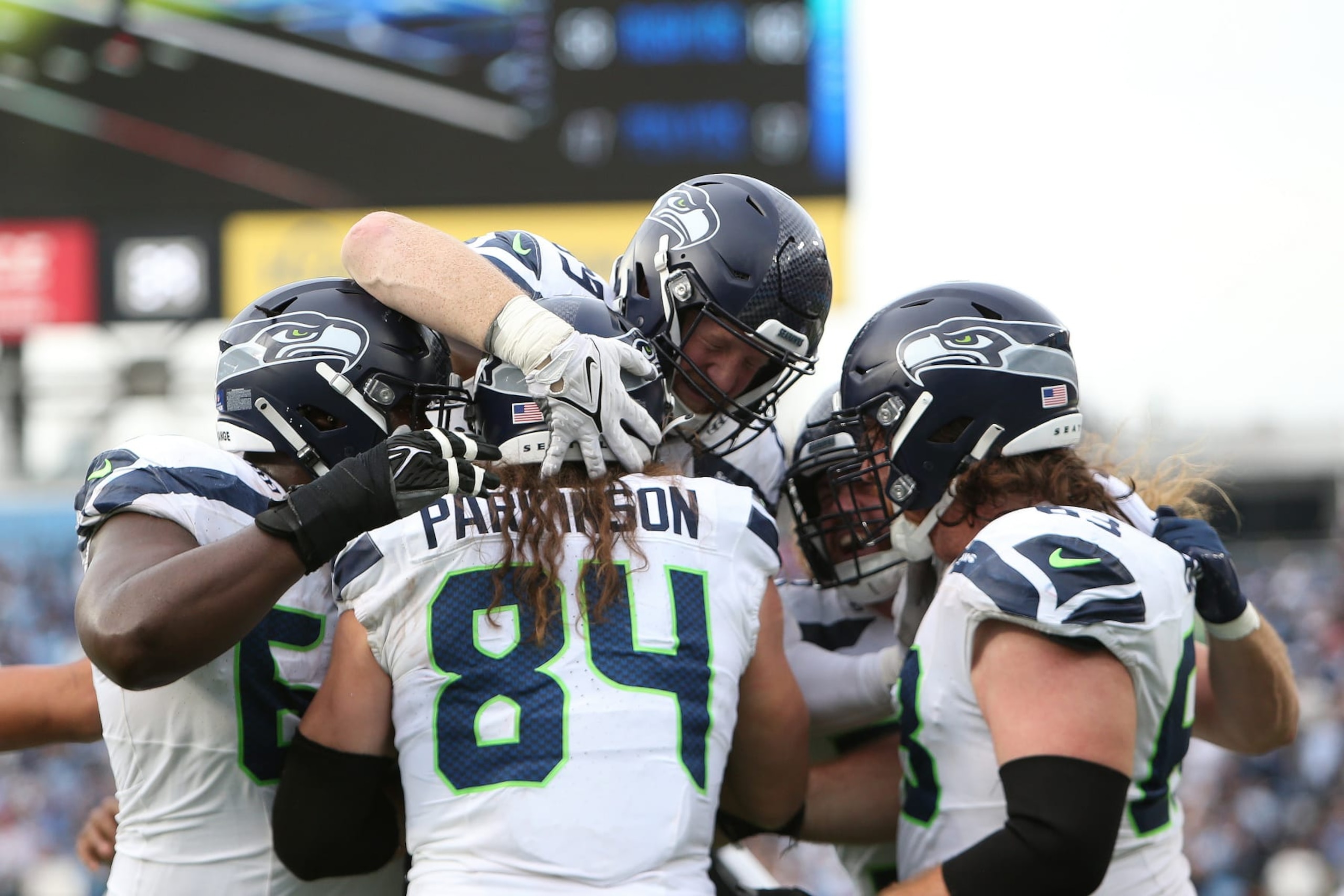 NASHVILLE, TN - DECEMBER 24: Seattle Seahawks tight end Colby Parkinson (84) is hugged by teammates after scoring a touchdown  during a game between the Tennessee Titans and Seattle Seahawks, December 24, 2023 at Nissan Stadium in Nashville, Tennessee. (Photo by Matthew Maxey/Icon Sportswire via Getty Images)