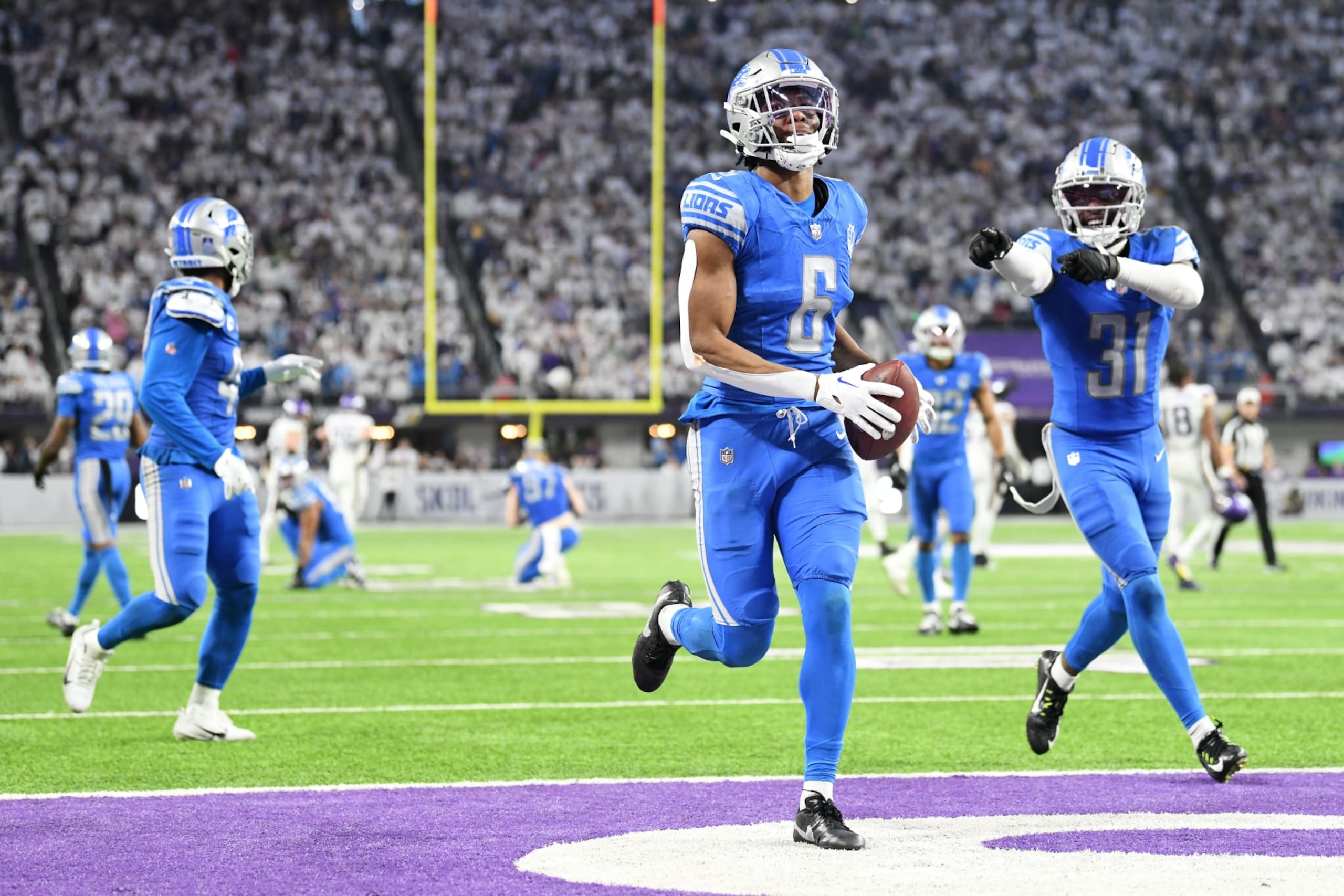 MINNEAPOLIS, MINNESOTA - DECEMBER 24:  Ifeatu Melifonwu #6 of the Detroit Lions is congratulated by Kerby Joseph #31 after an interception against the Minnesota Vikings at the end of the fourth quarter at U.S. Bank Stadium on December 24, 2023 in Minneapolis, Minnesota. (Photo by Stephen Maturen/Getty Images)