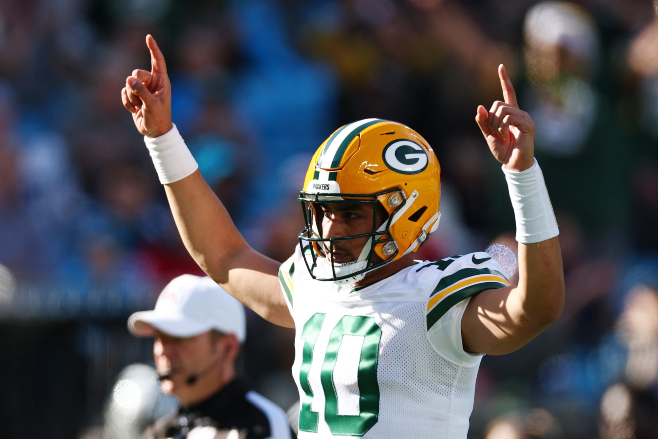 CHARLOTTE, NORTH CAROLINA - DECEMBER 24: Jordan Love #10 of the Green Bay Packers celebrates after AJ Dillon #28 of the Green Bay Packers scores a rushing touchdown during the first quarter against the Carolina Panthers at Bank of America Stadium on December 24, 2023 in Charlotte, North Carolina. (Photo by Jared C. Tilton/Getty Images)