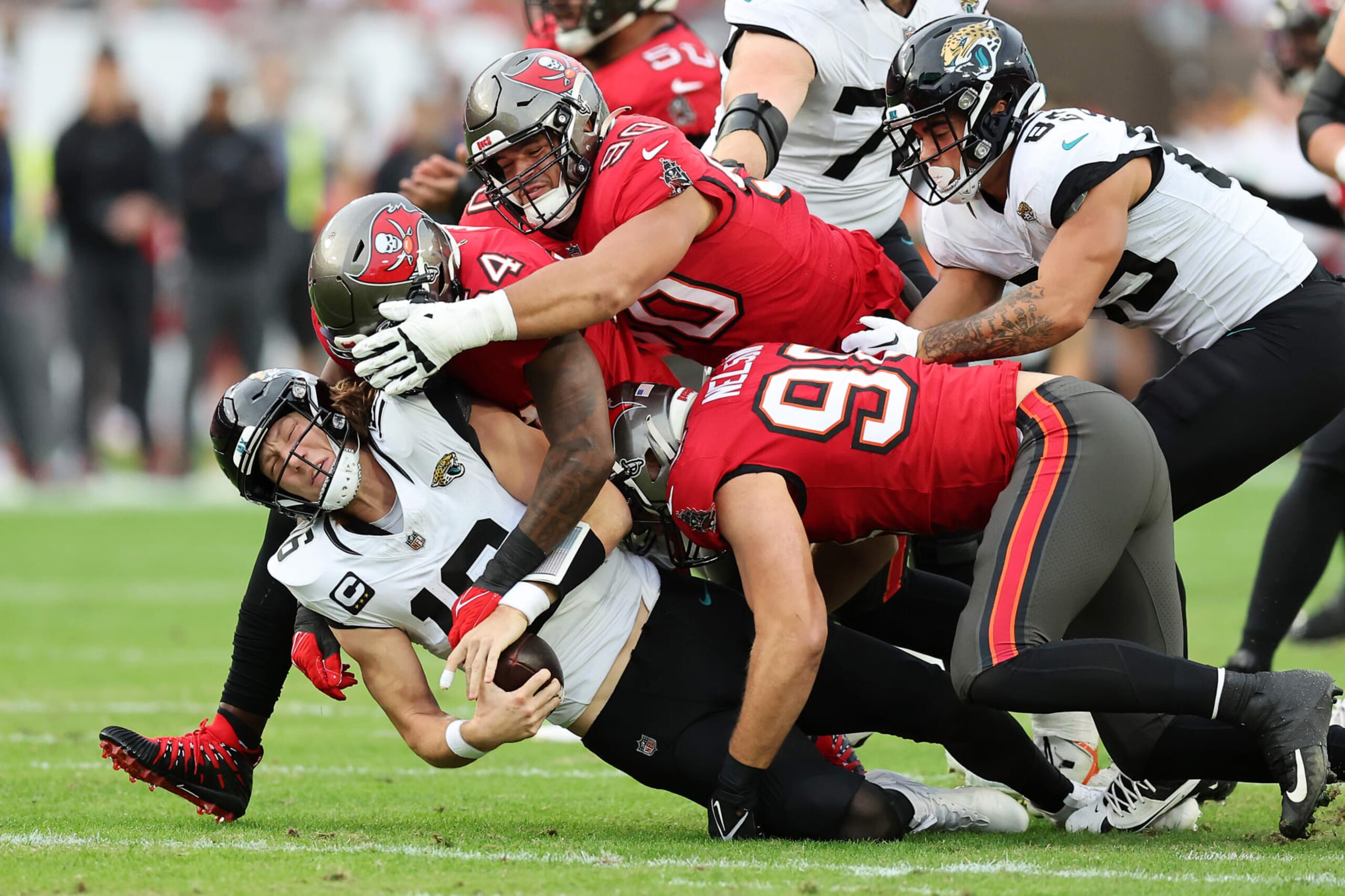 TAMPA, FLORIDA - DECEMBER 24:  Trevor Lawrence #16 of the Jacksonville Jaguars is sacked by Lavonte David #54 of the Tampa Bay Buccaneers during the second quarter at Raymond James Stadium on December 24, 2023 in Tampa, Florida. (Photo by Mike Carlson/Getty Images)