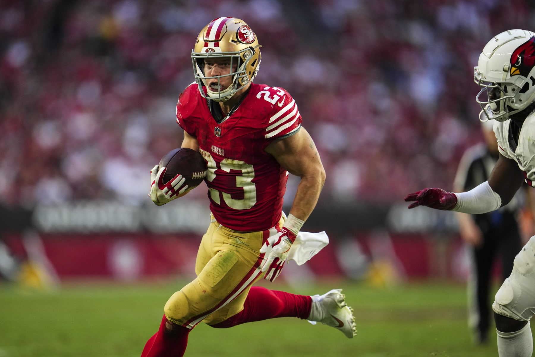 GLENDALE, AZ - DECEMBER 17: Christian McCaffrey #23 of the San Francisco 49ers runs the ball during an NFL football game against the Arizona Cardinals at State Farm Stadium on December 17, 2023 in Glendale, Arizona. (Photo by Cooper Neill/Getty Images)