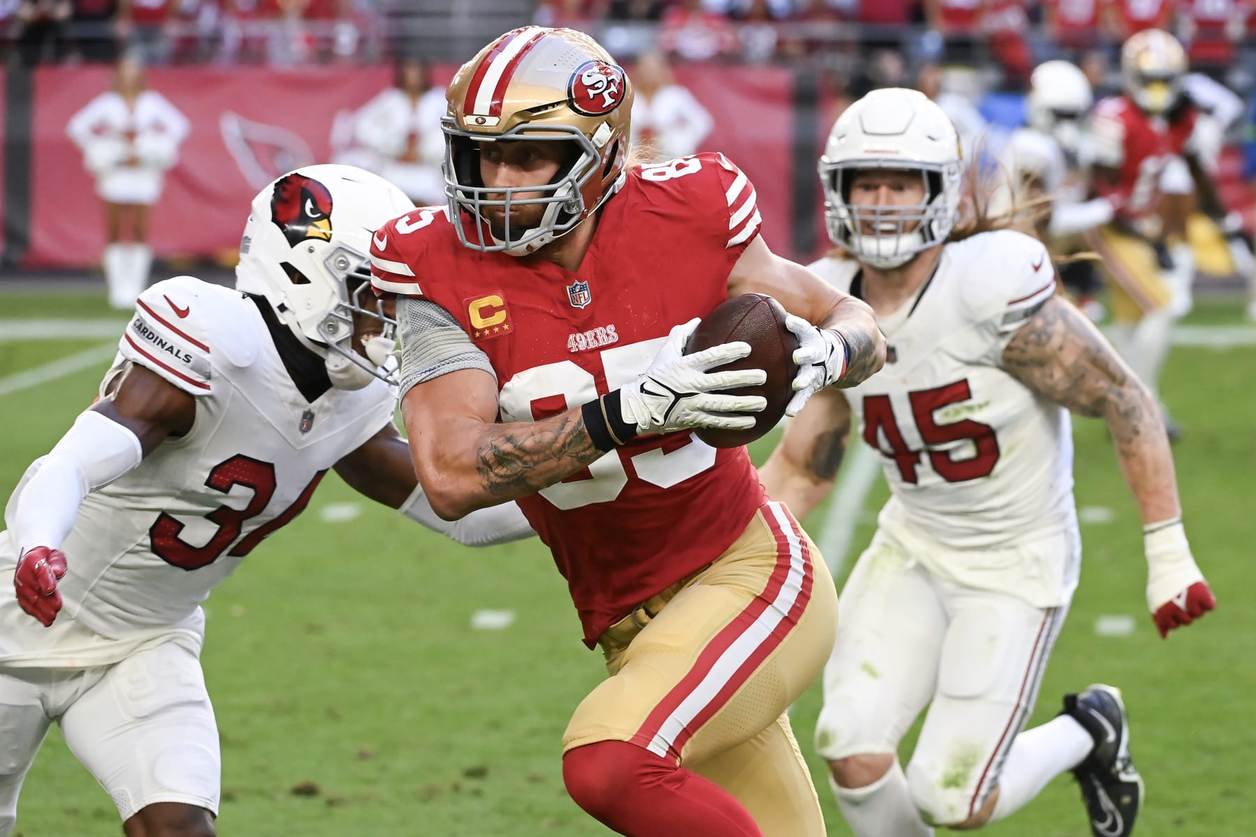 GLENDALE, ARIZONA - DECEMBER 17: George Kittle #85 of the San Francisco 49ers runs with the ball during the second quarter of a game against the Arizona Cardinals at State Farm Stadium on December 17, 2023 in Glendale, Arizona. (Photo by Norm Hall/Getty Images)