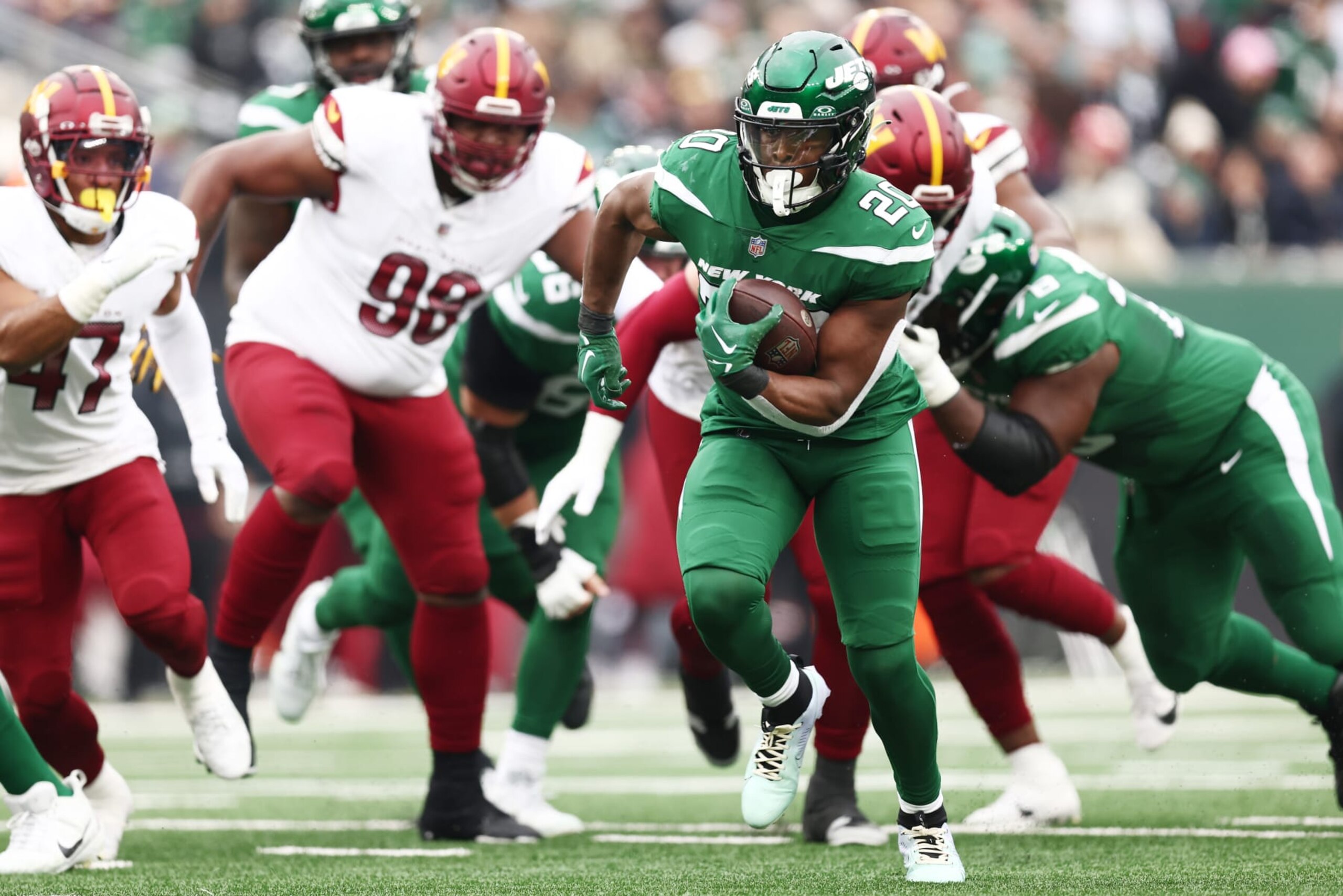 EAST RUTHERFORD, NEW JERSEY - DECEMBER 24: Breece Hall #20 of the New York Jets rushes for a touchdown during the first quarter against the Washington Commanders at MetLife Stadium on December 24, 2023 in East Rutherford, New Jersey. (Photo by Dustin Satloff/Getty Images)